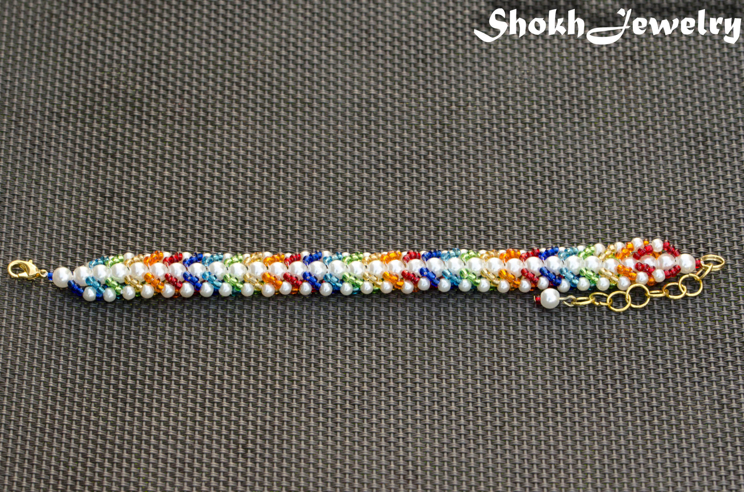 Top view of Rainbow seed bead and pearl woven bracelet.