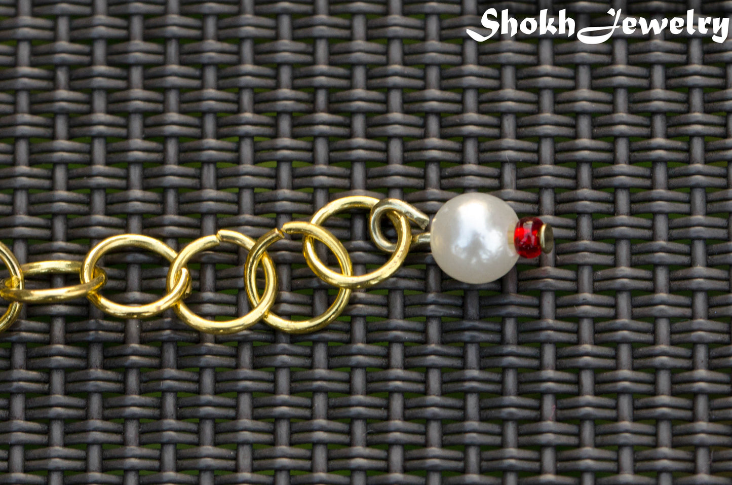 Rainbow seed bead and pearl woven bracelet with a cute little dangle.
