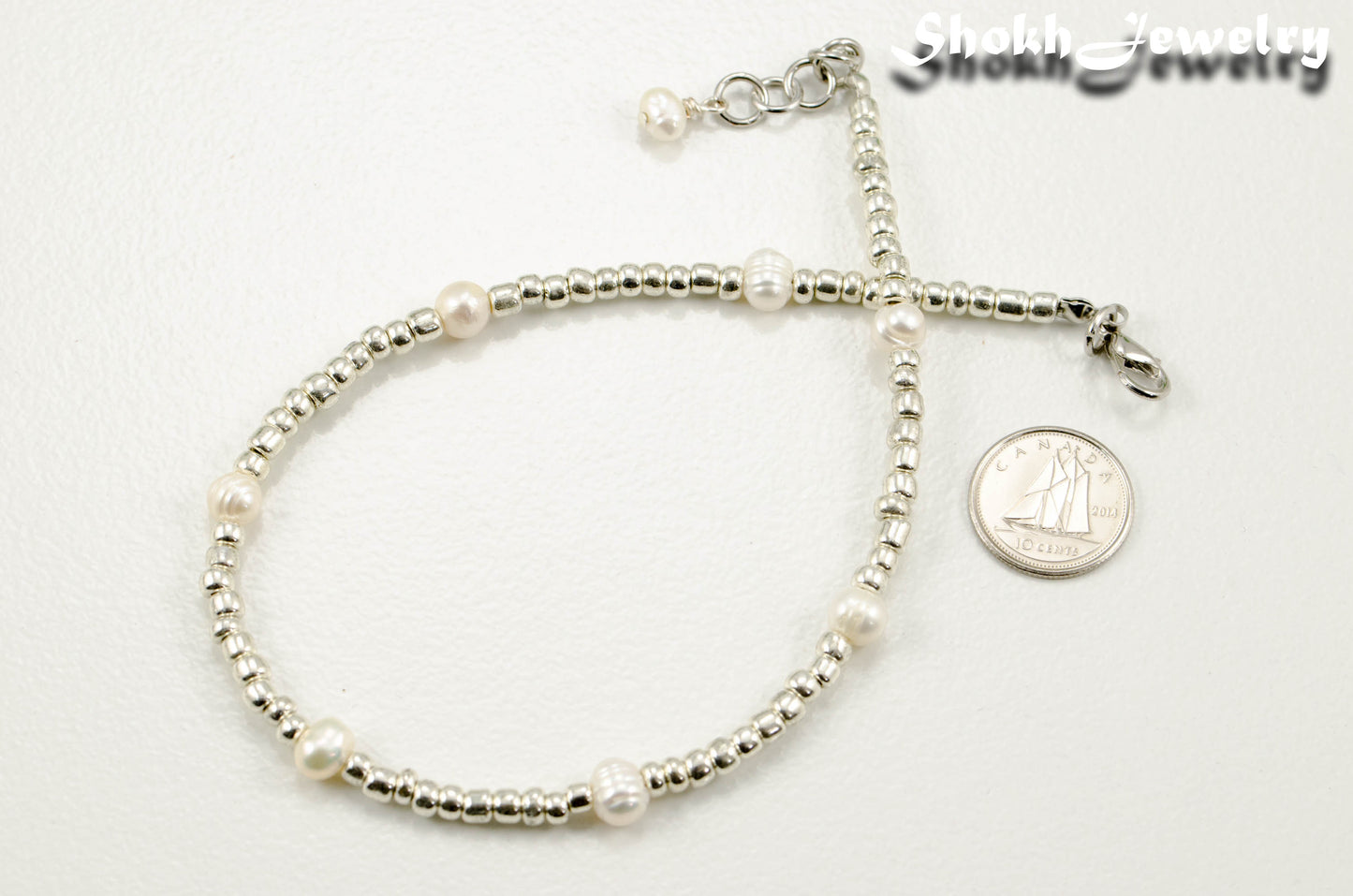 Freshwater Pearl and Silver Seed Bead Anklet beside a dime.