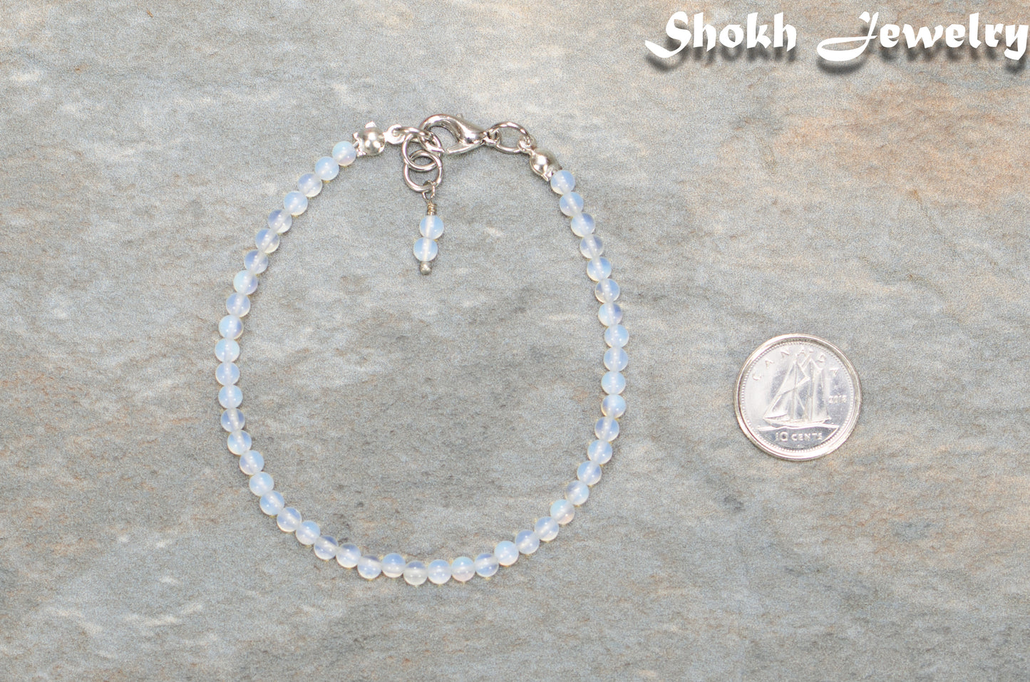 3mm Clear White Opalite Anklet beside a dime.