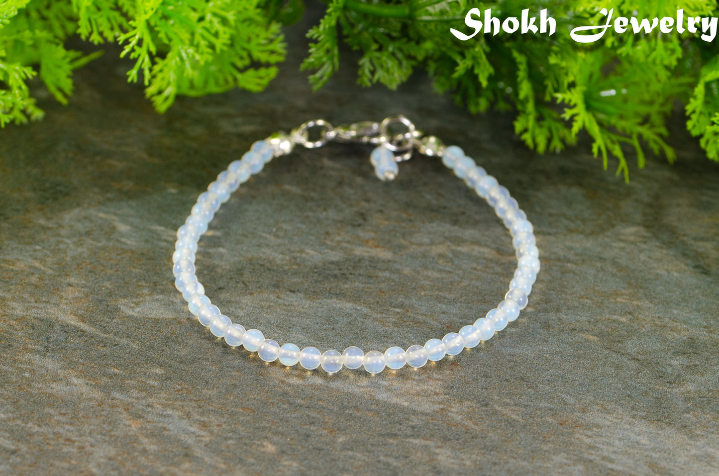 3mm Clear White Opalite Anklet on a stone surface.