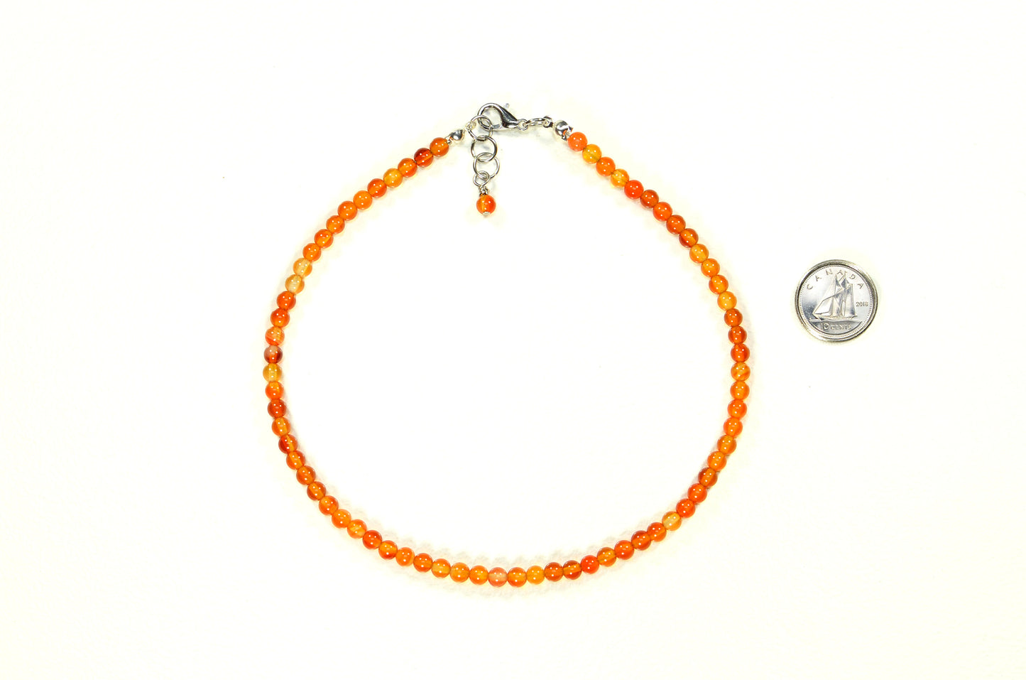 4mm Carnelian Crystal Choker Necklace beside a dime.