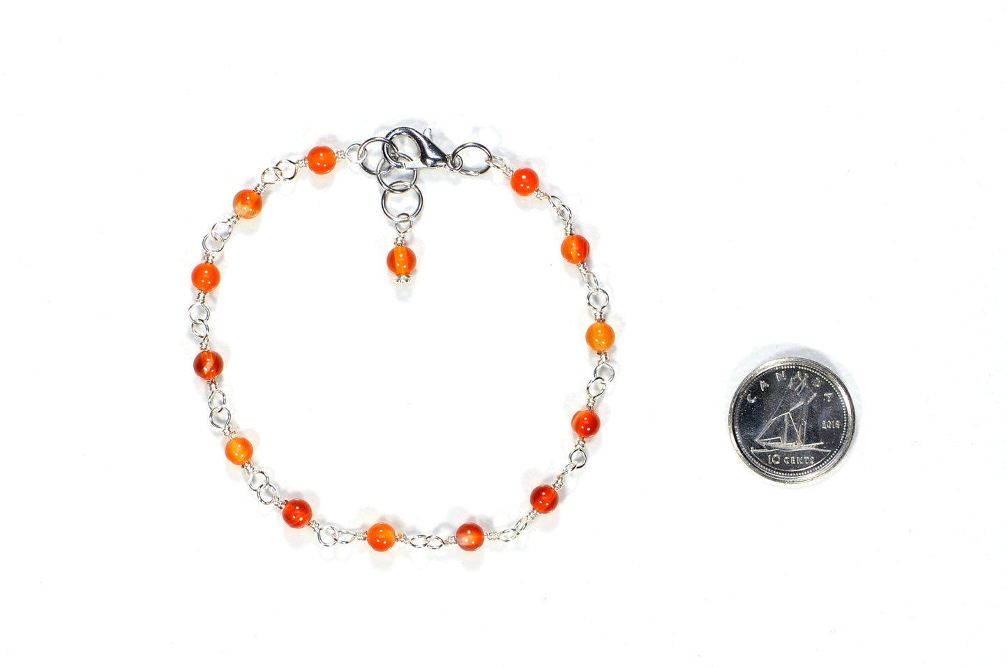4mm Carnelian Link Anklet beside a dime.