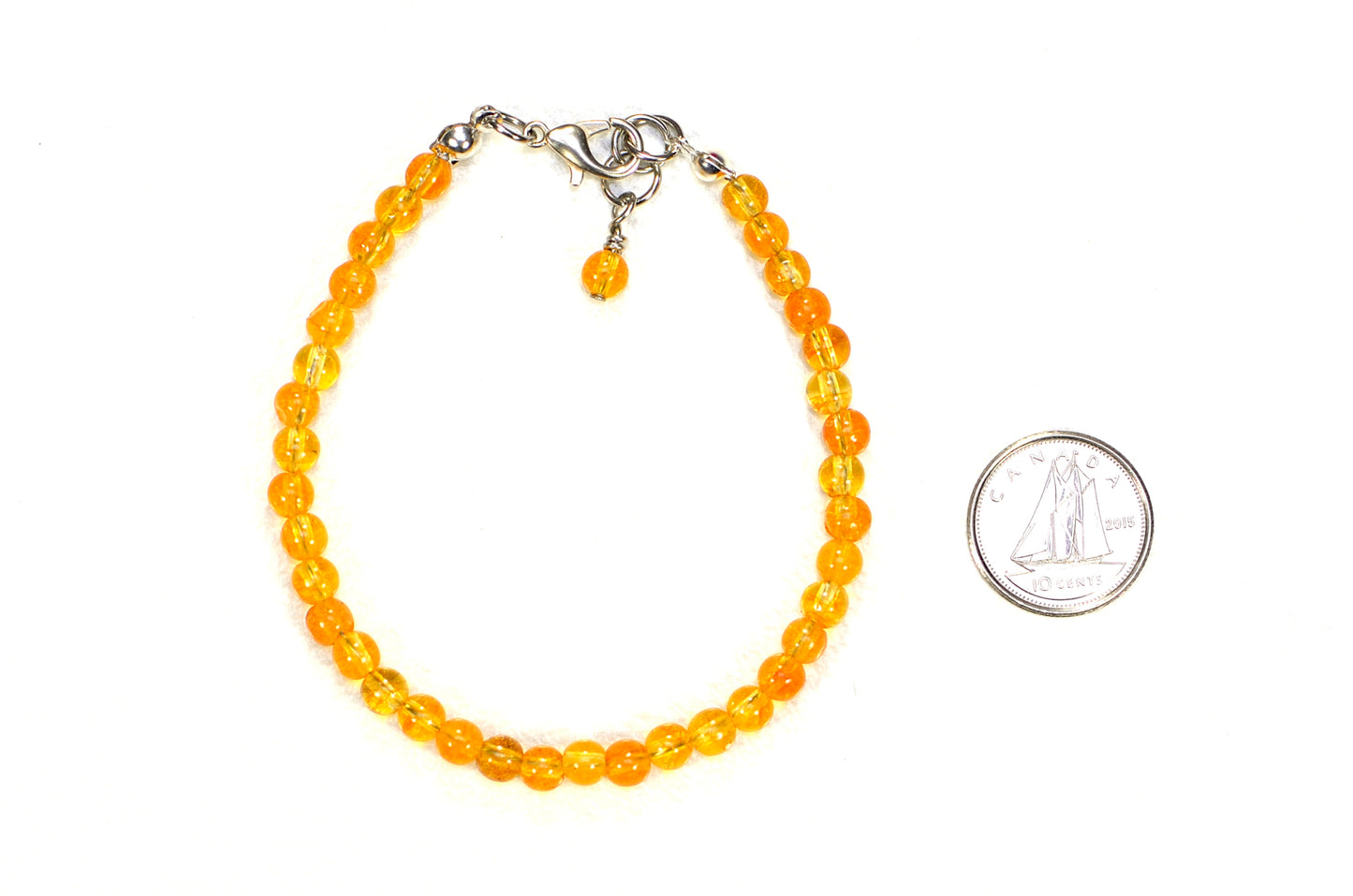 4mm Natural Citrine Anklet beside a dime.