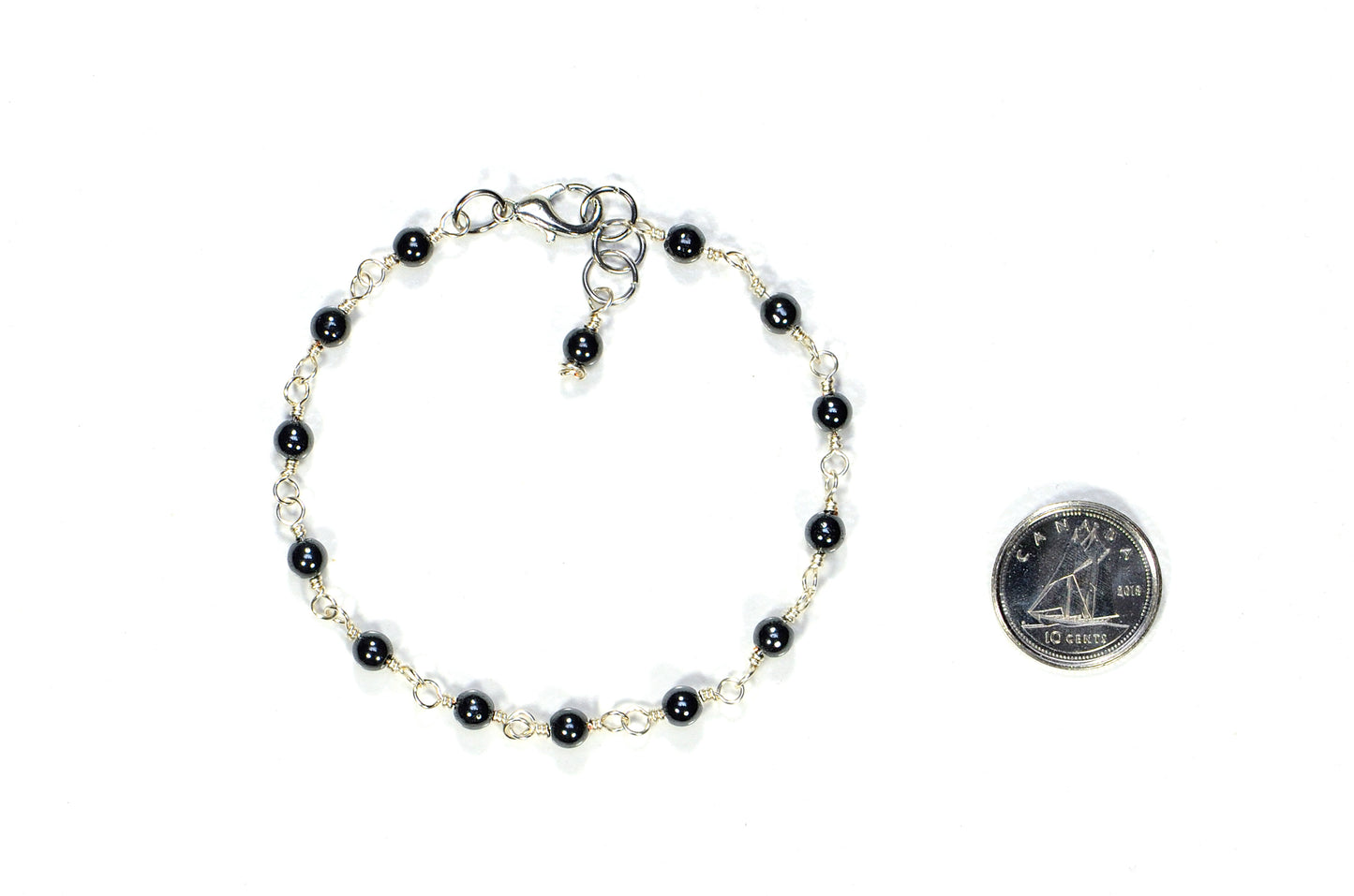 4mm Natural Hematite Link Chain Anklet beside a dime.