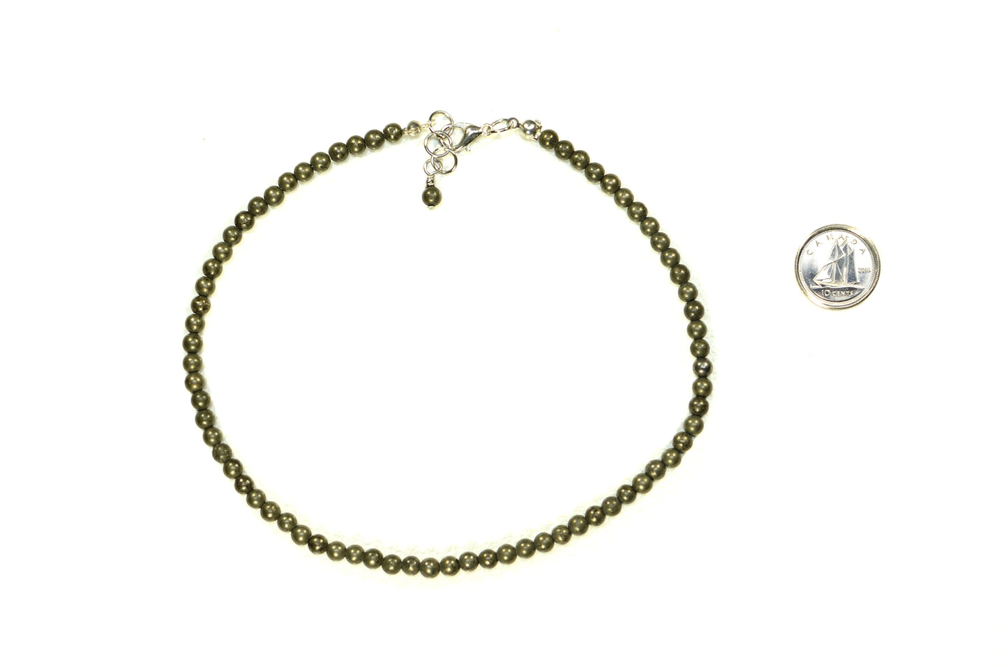 4mm Natural Pyrite Crystal Choker Necklace beside a dime.