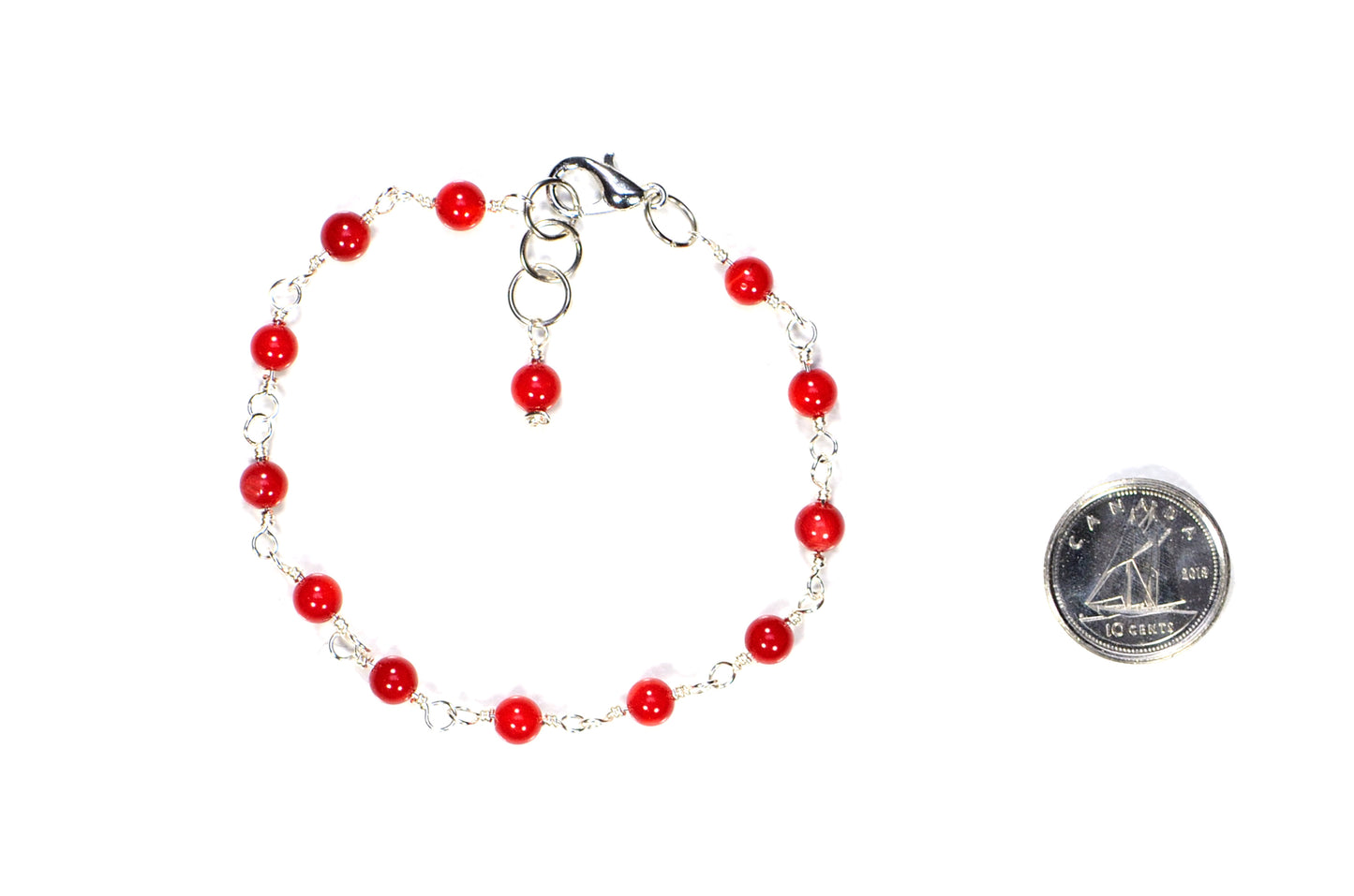 4mm Natural Red Dyed Coral Link Anklet beside a dime.