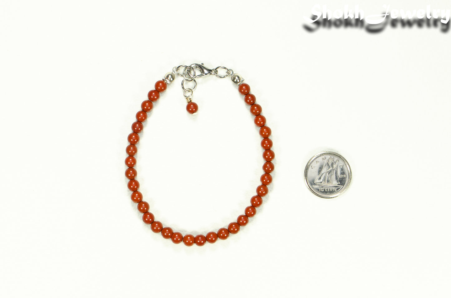 4mm Natural Red Jasper anklet with Clasp beside a dime.