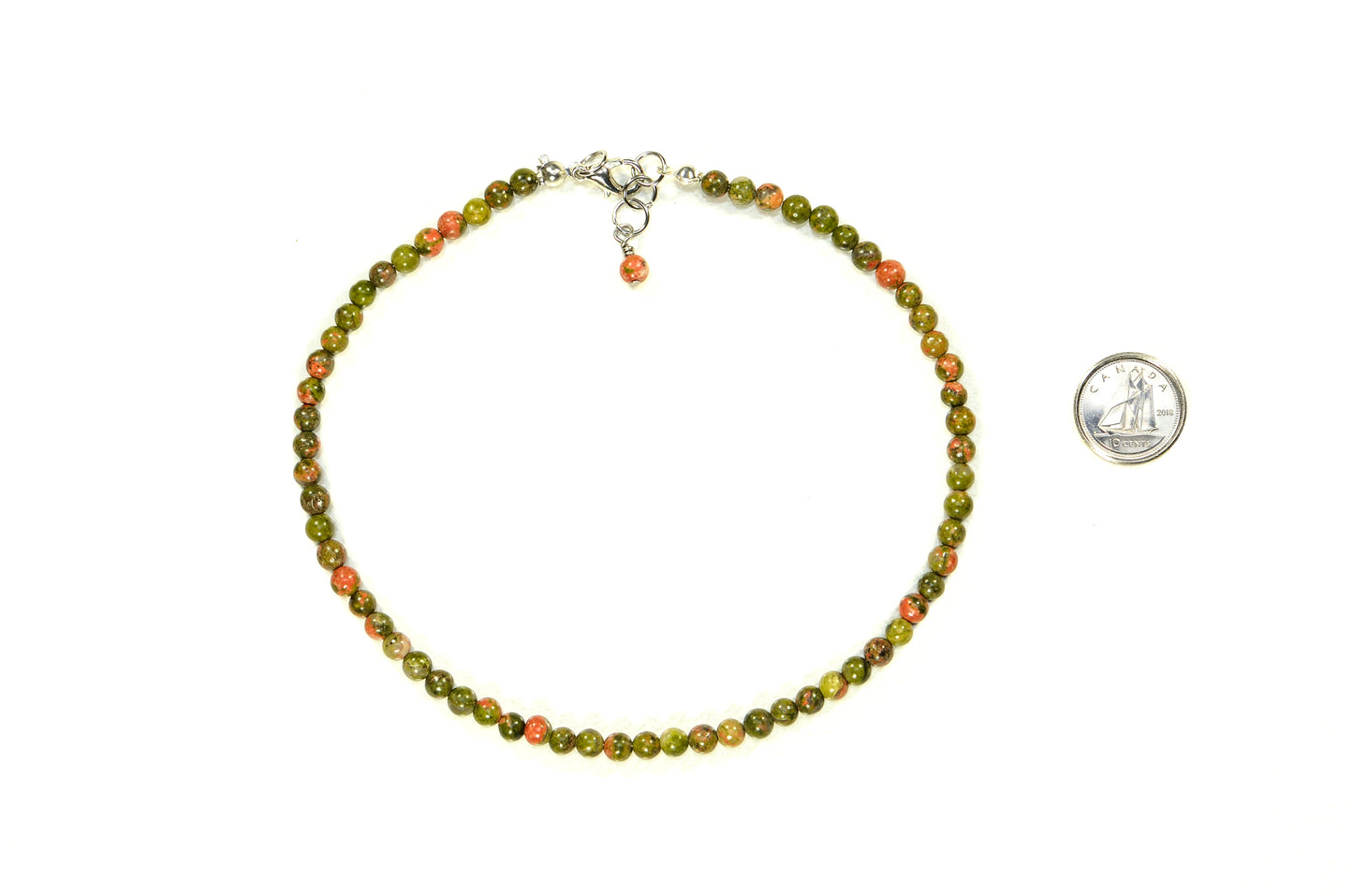 4mm Natural Unakite Choker Necklace beside a dime.