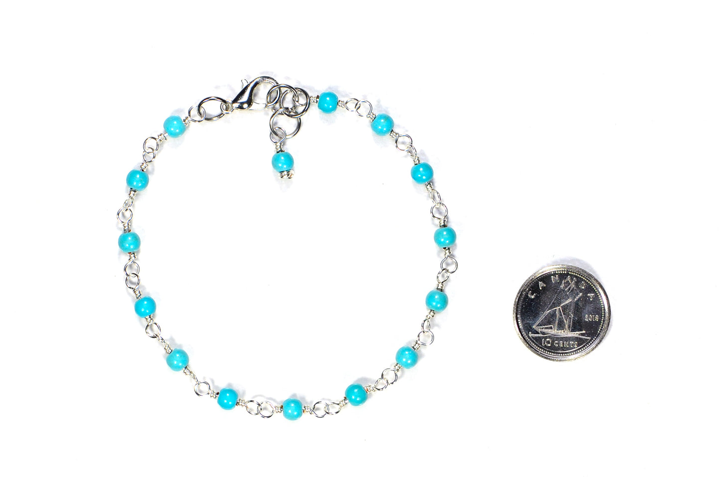 4mm Turquoise Howlite Link Anklet beside a dime.