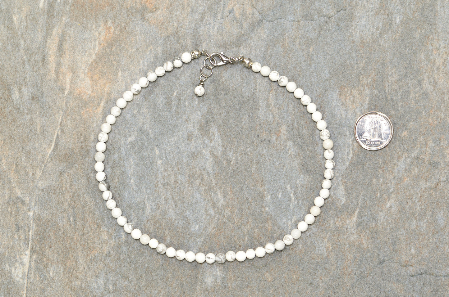 4mm White Howlite Choker Necklace beside a dime.