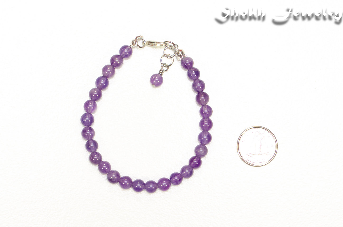 6mm Amethyst Anklet beside a dime.