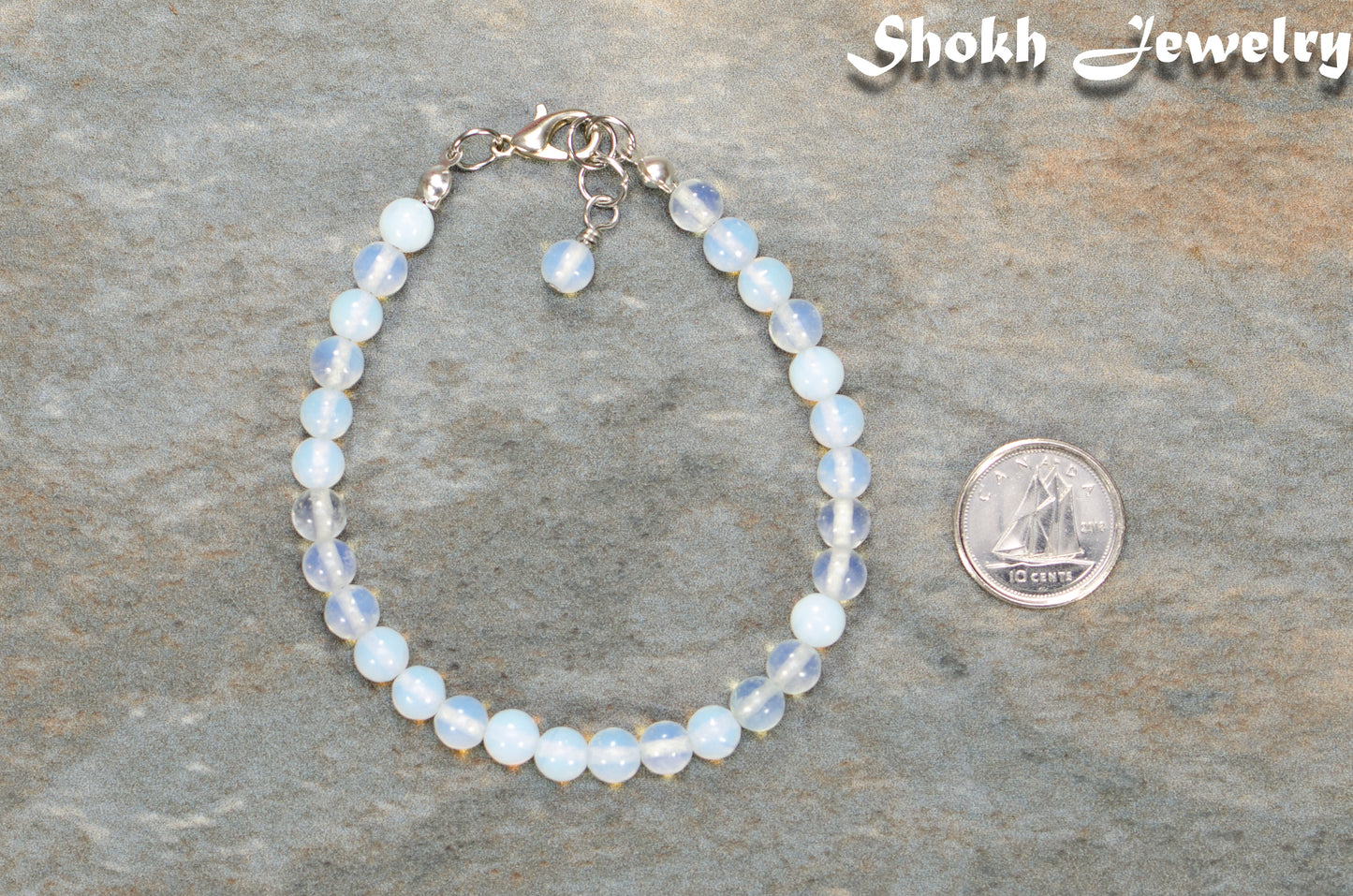 6mm Clear White Opalite Beaded Anklet beside a dime.