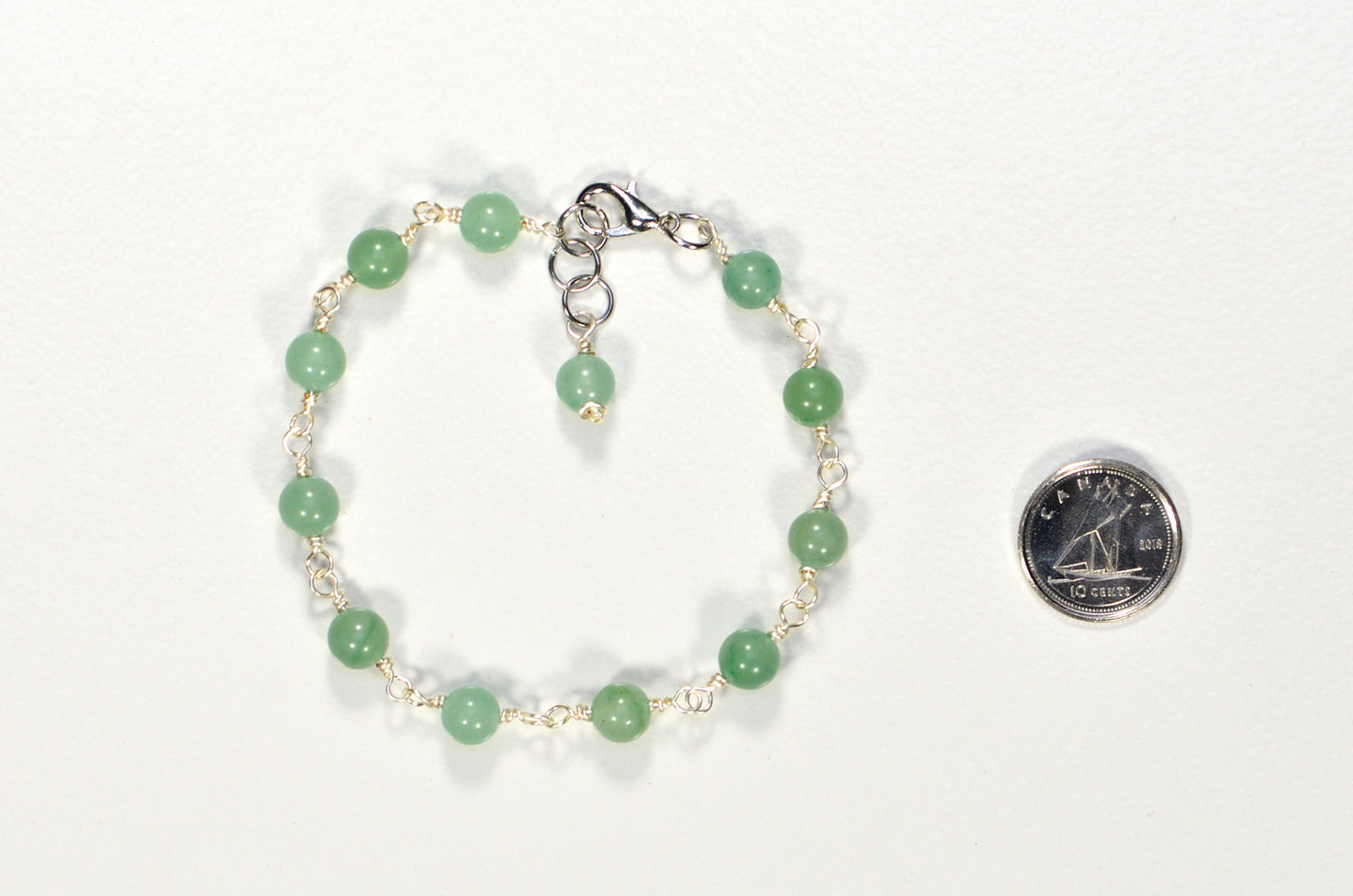 6mm Green Aventurine Link Bracelet beside a dime.