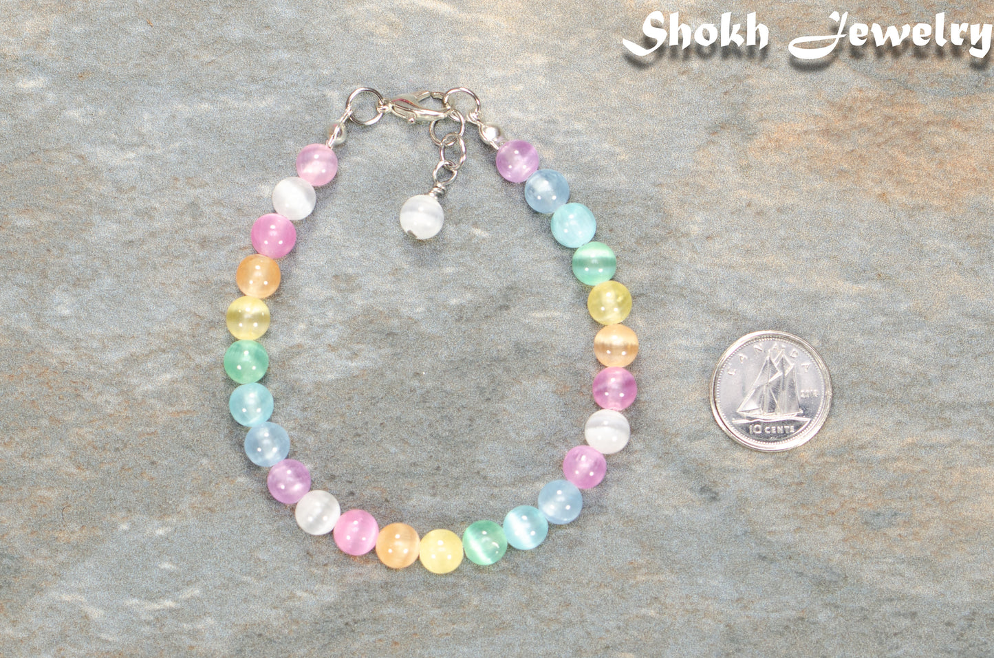 6mm Rainbow Selenite Anklet beside a dime.