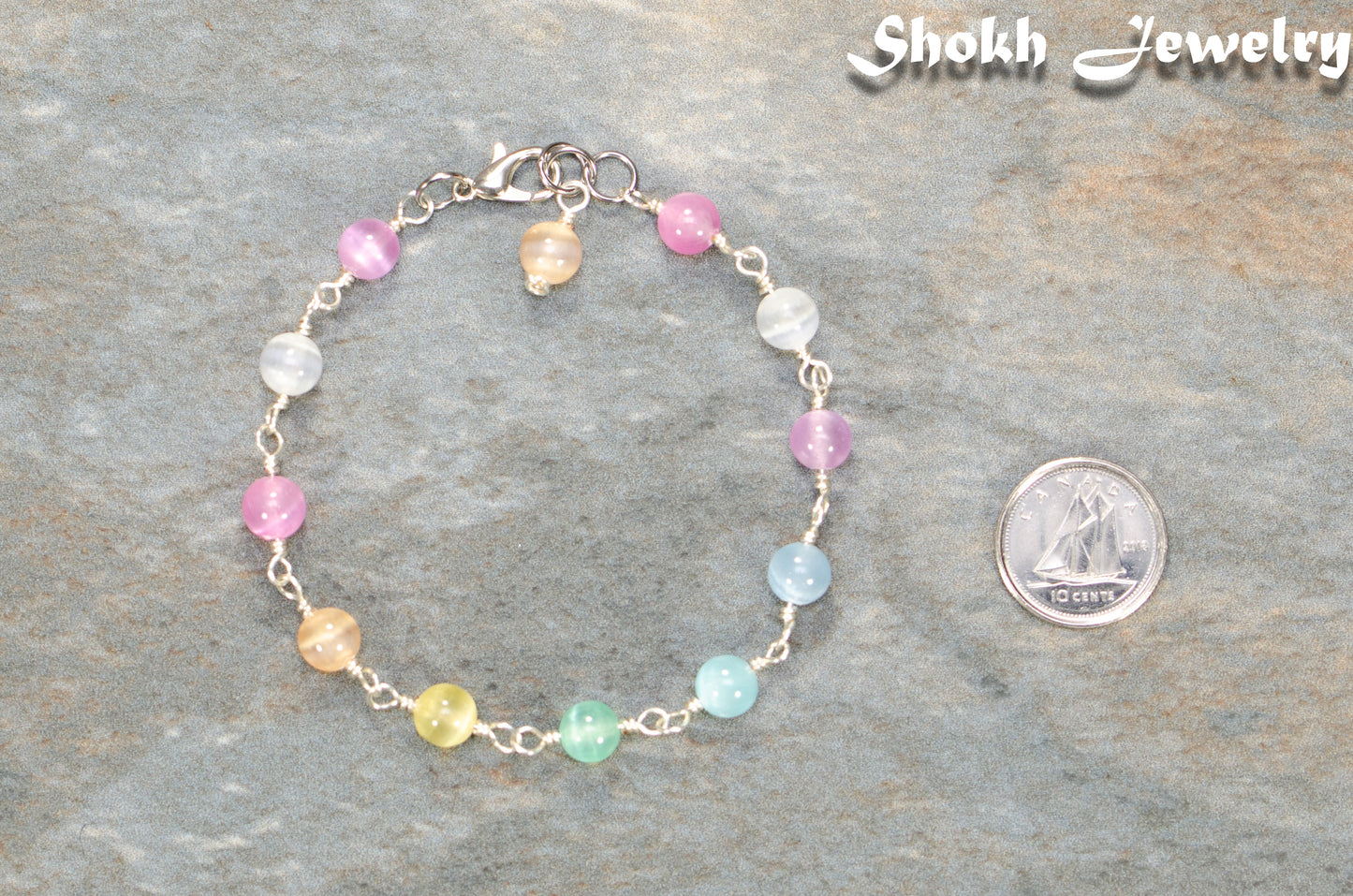 6mm Rainbow Selenite Link Anklet beside a dime.