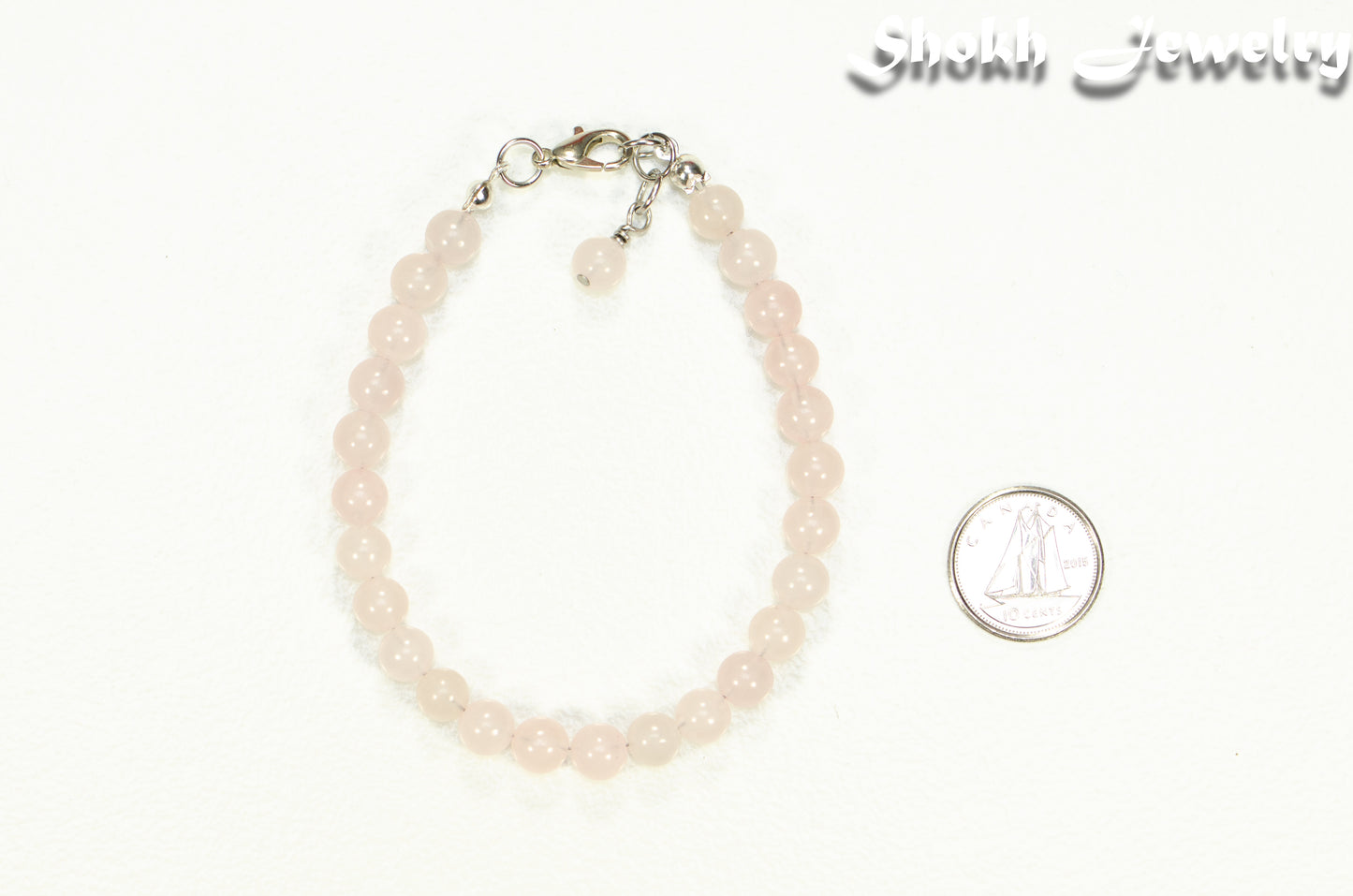 6mm Rose Quartz Beaded Anklet beside a dime.