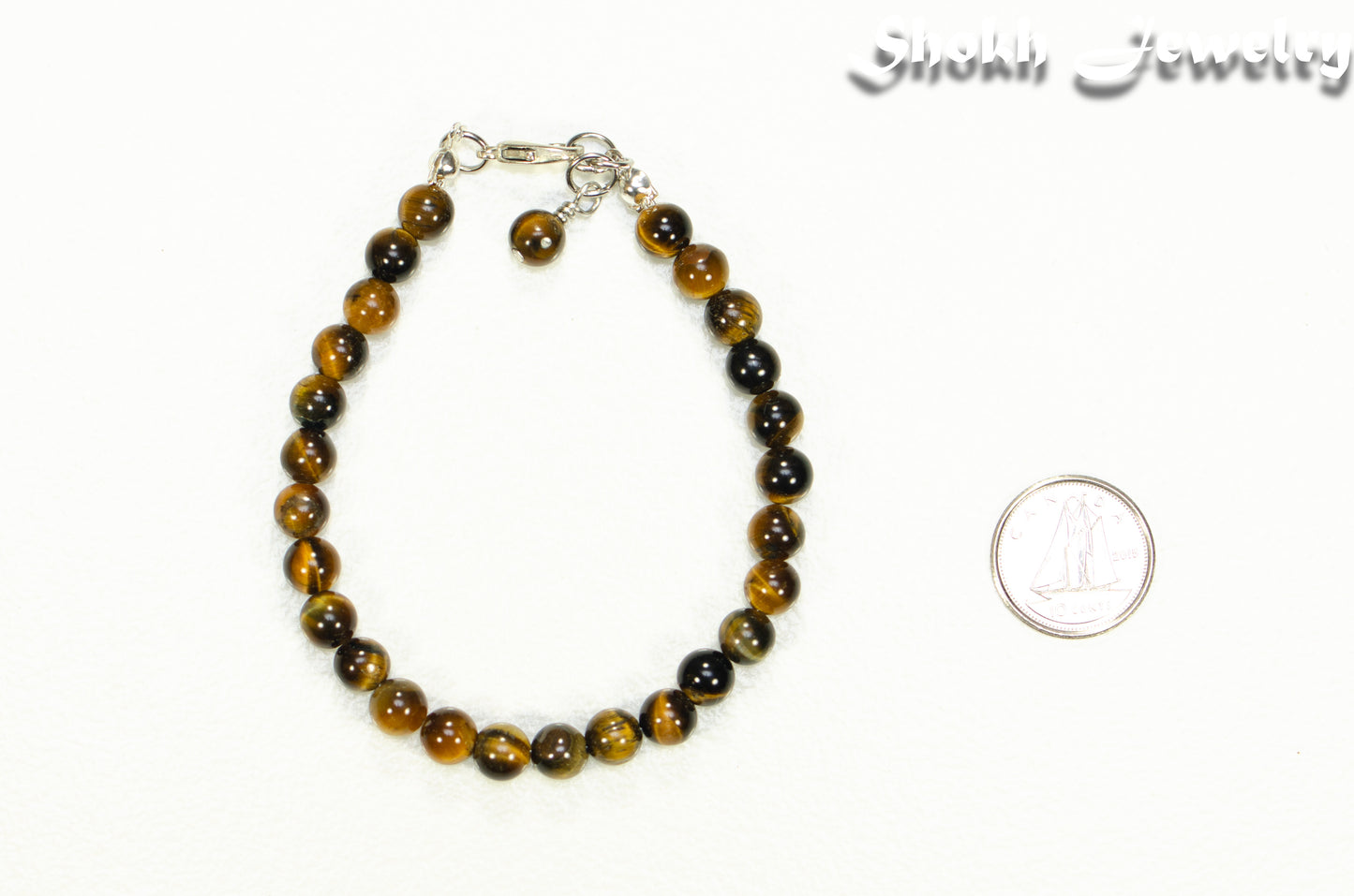 6mm Tiger's Eye Beaded Anklet beside a dime.