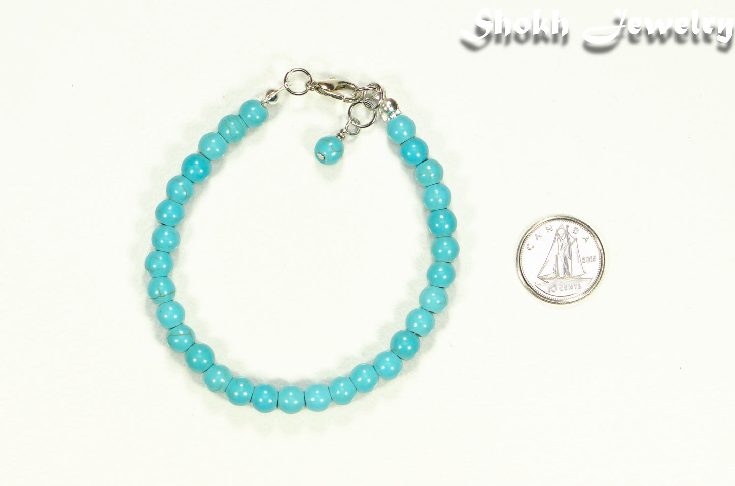 6mm Turquoise Howlite Beaded Anklet beside a dime.