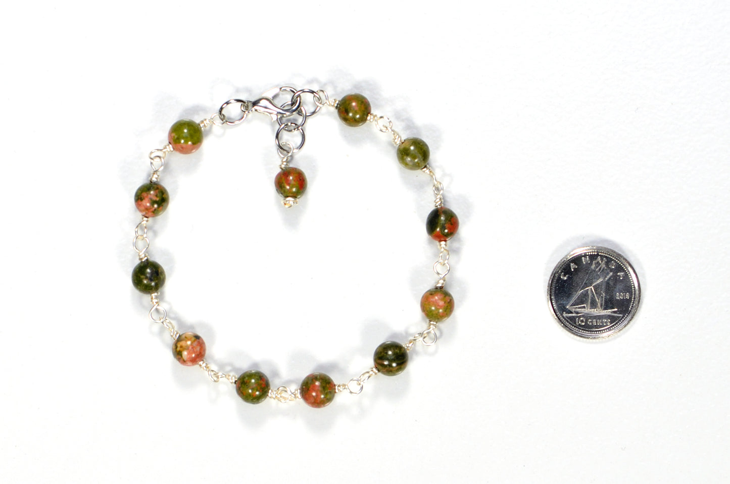 6mm Unakite Jasper Link Bracelet beside a dime.