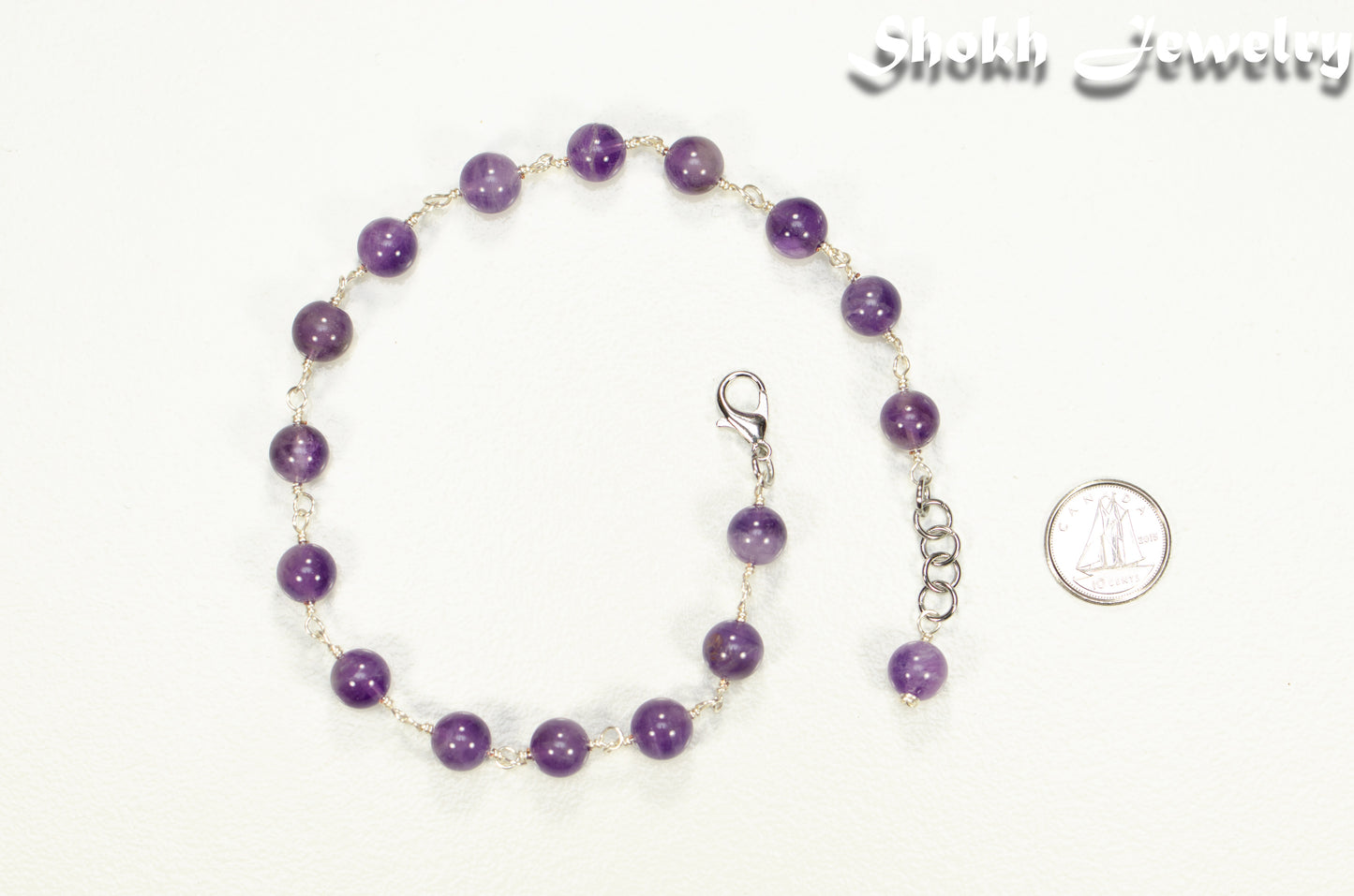 8mm Amethyst Crystal Link Choker Necklace beside a dime.