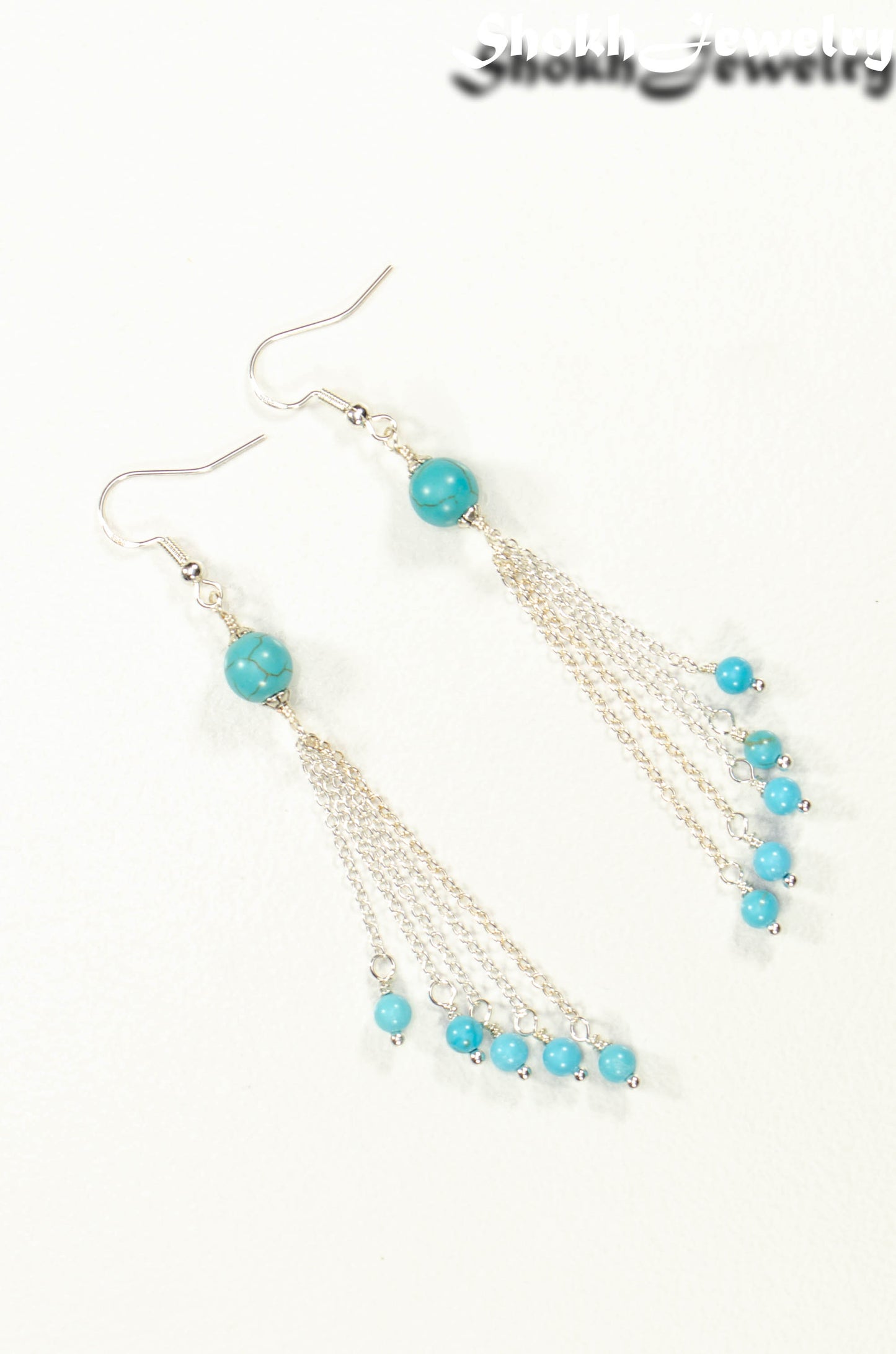Top view of Cascading Turquoise Howlite Gemstone Drop Earrings.