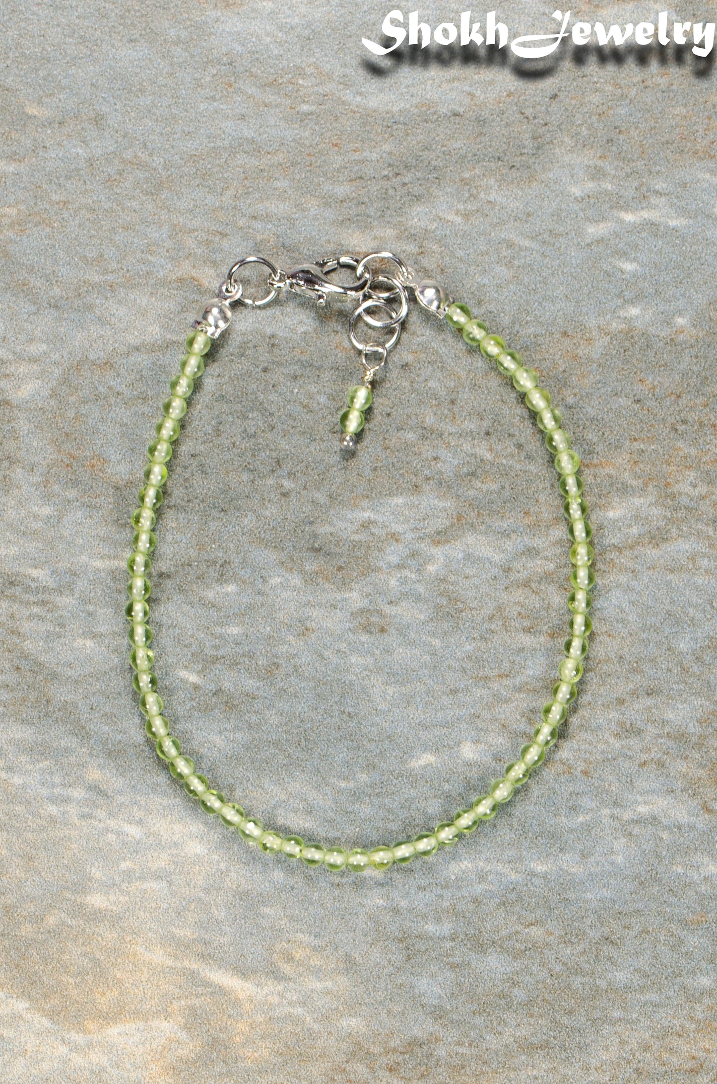 Top view of Dainty Peridot anklet for women.