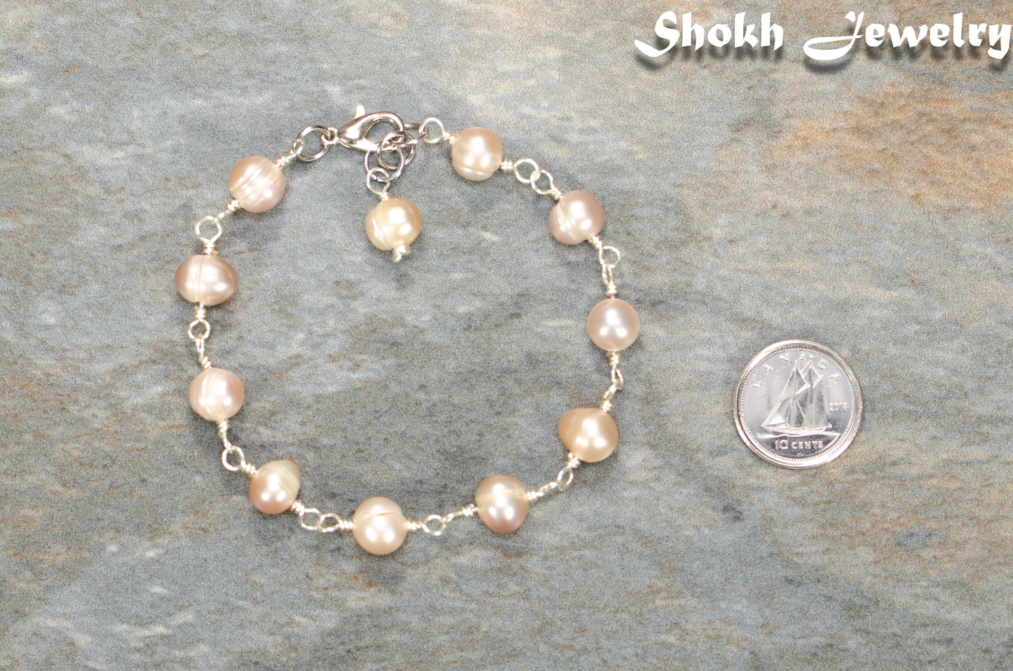 Lavender Freshwater Pearls Link Chain Bracelet beside a dime.