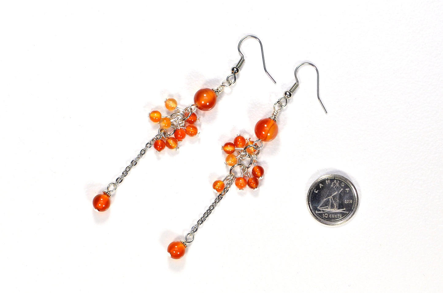 Long Stainless Steel Chain and Carnelian Earrings beside a dime.