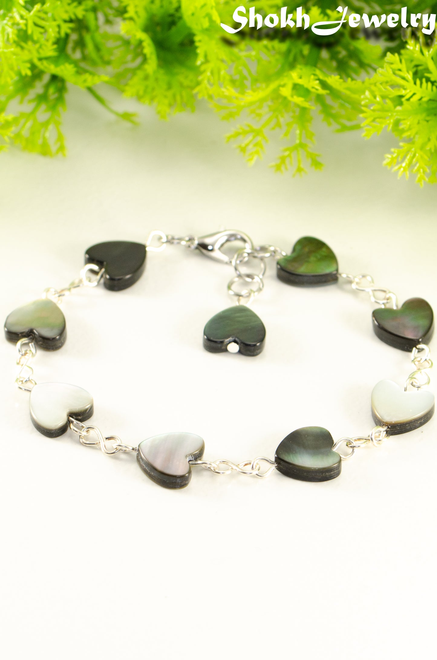 Close up of Grey Seashell Heart Link Bracelet.
