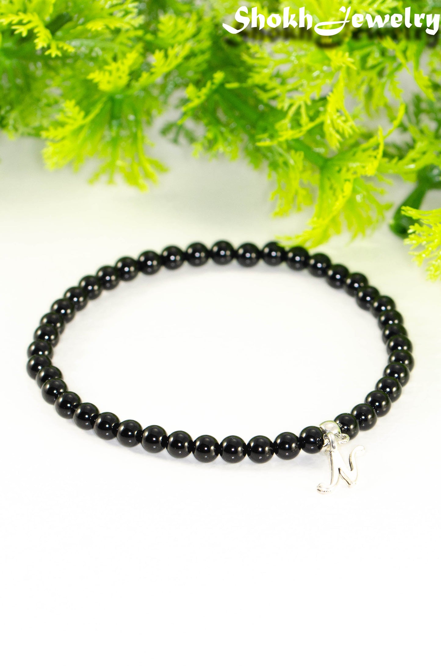 Close up of Black Obsidian Bracelet with Initial