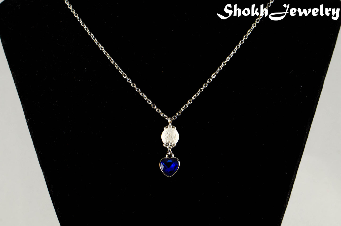 Lava Rock and Heart Shaped September Birthstone Choker Necklace displayed on a dime.