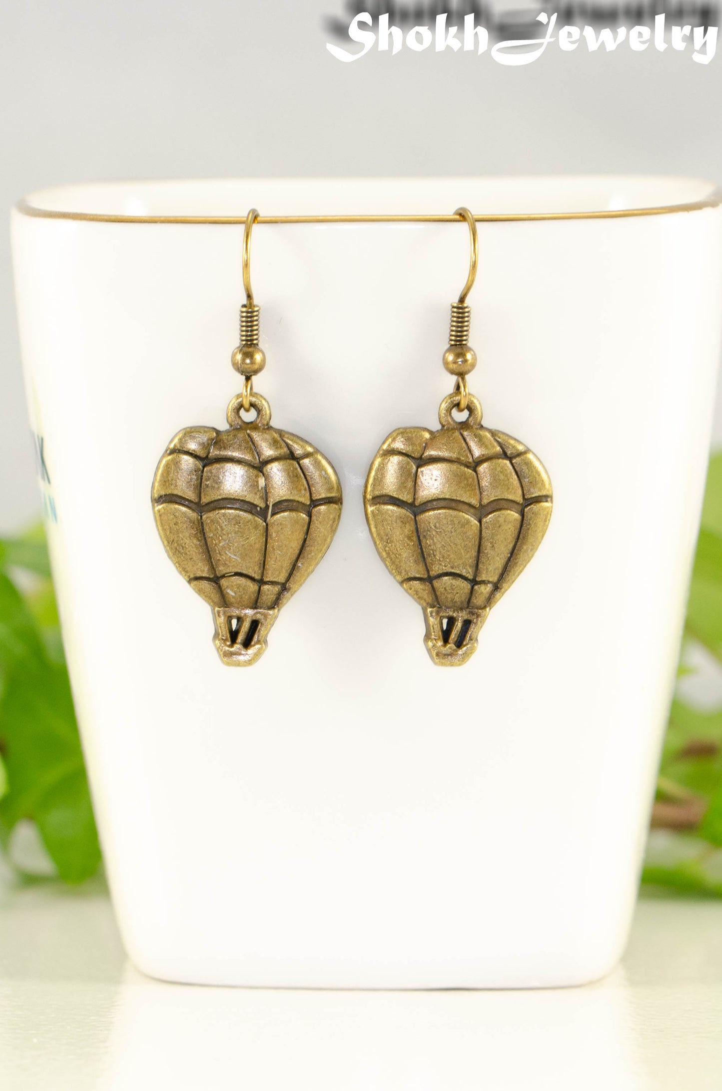 Close up of Antique Bronze Hot Air Balloon Charm Earrings.
