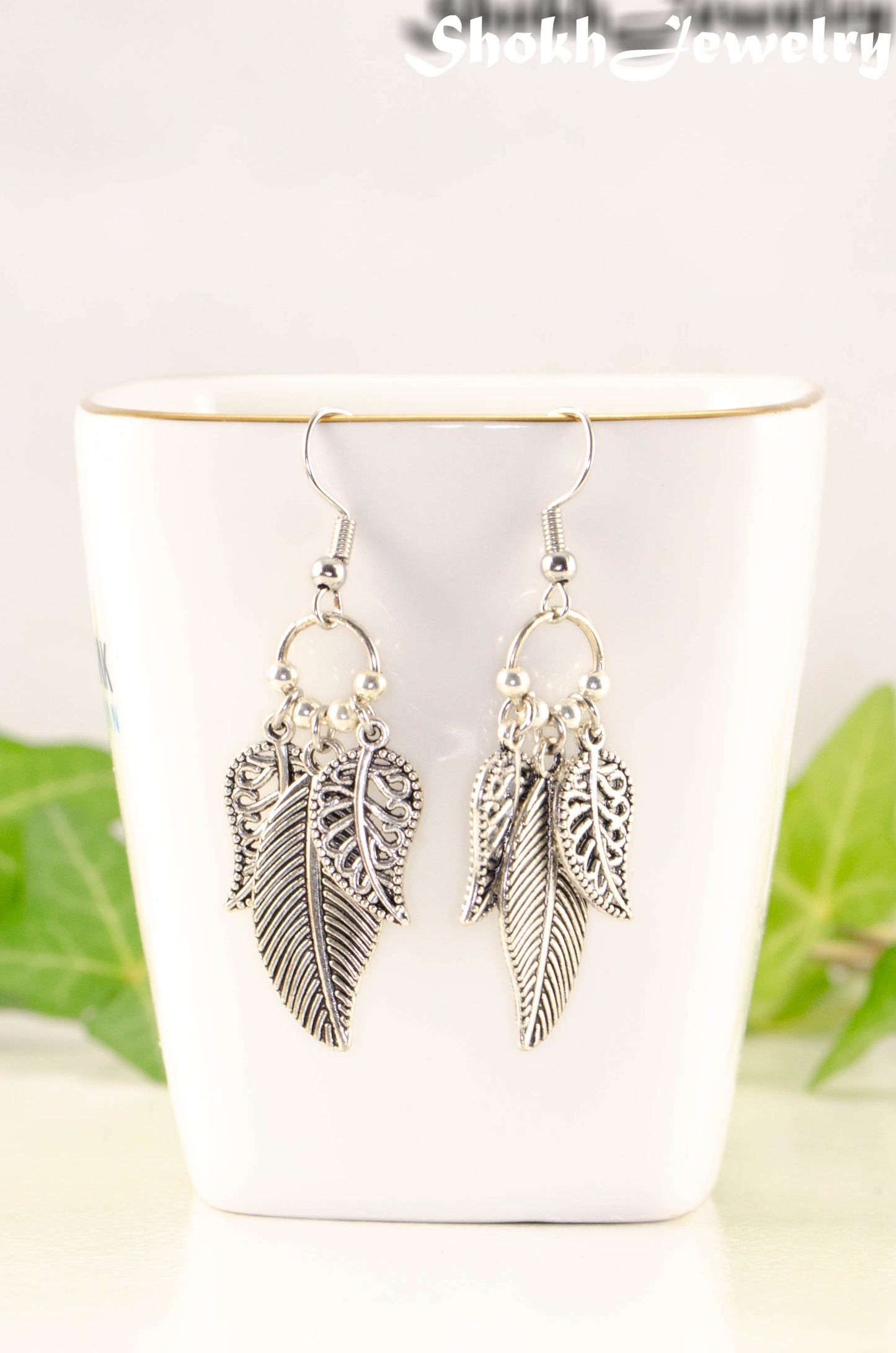 Close up of Statement Tibetan Silver Leaf Charm Earrings.