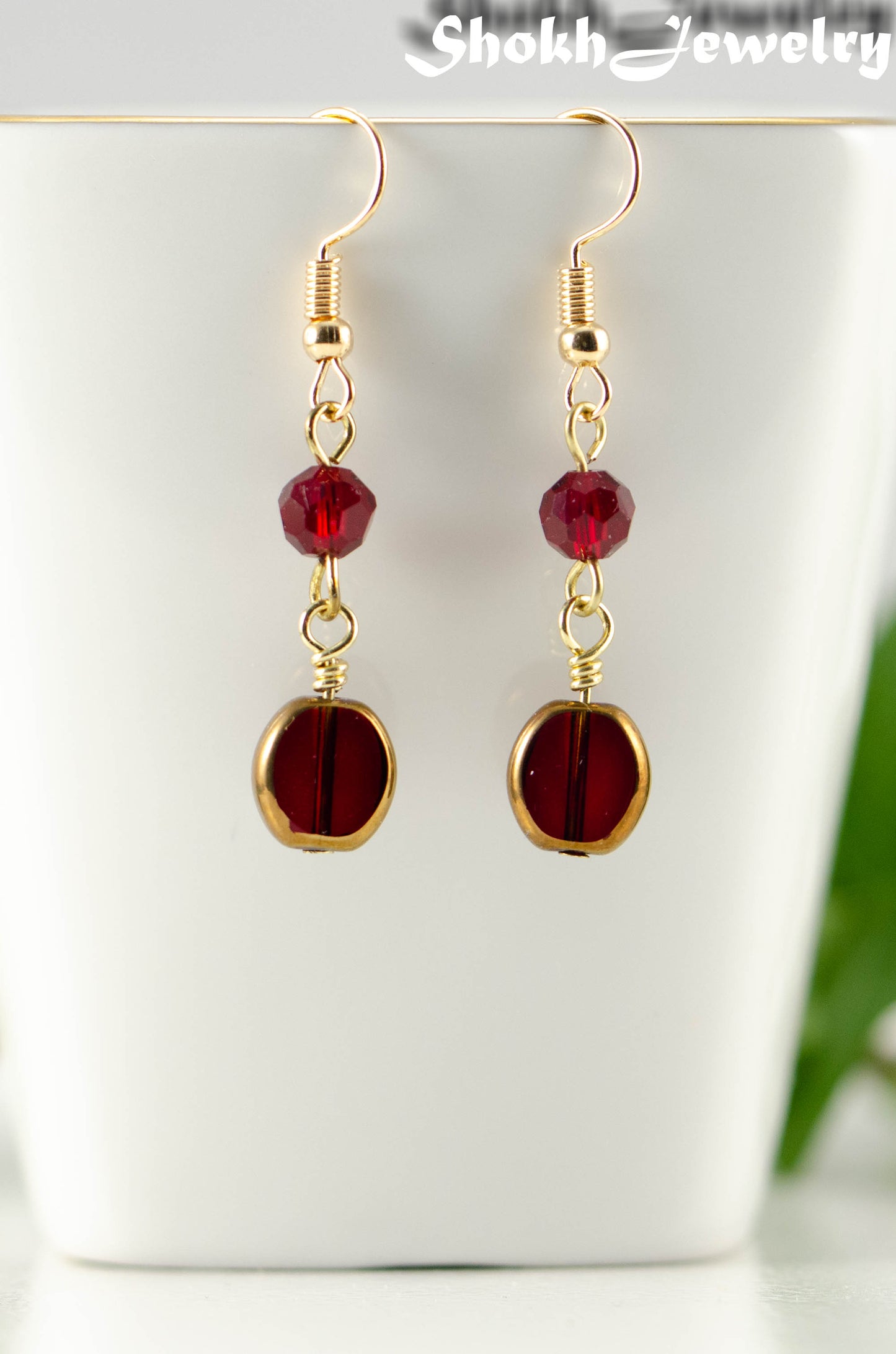 Close up of Dark Red and Gold Glass Bead Earrings.