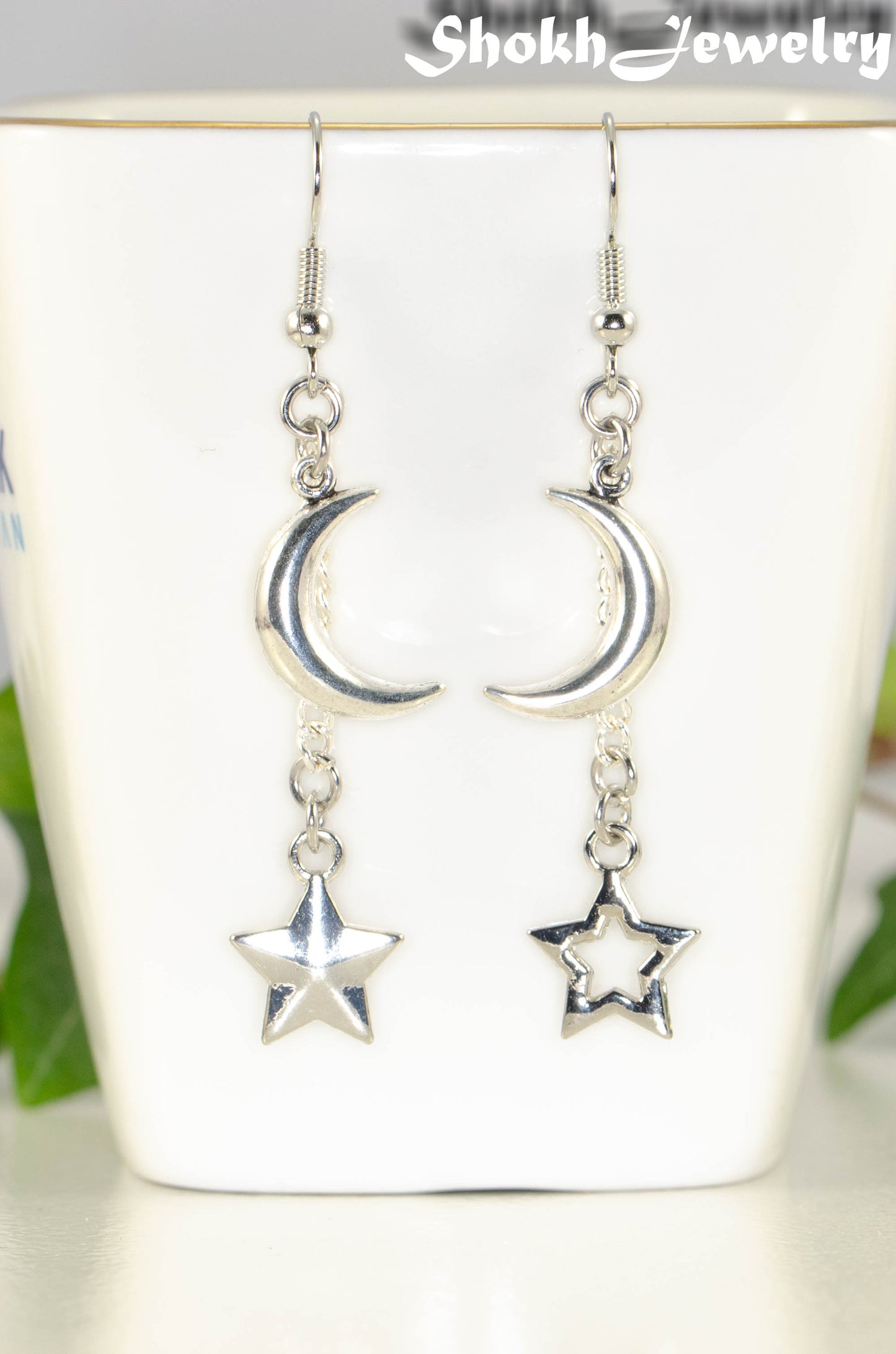 Close up of Crescent Moon and Mismatched Star Earrings.