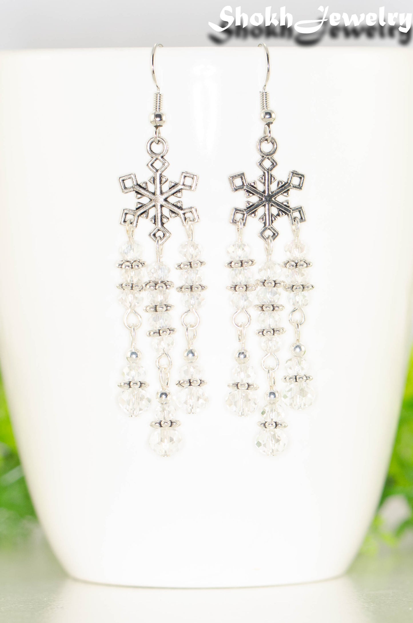 Close up of Clear Glass Crystal Chandelier and Snowflakes Earrings.
