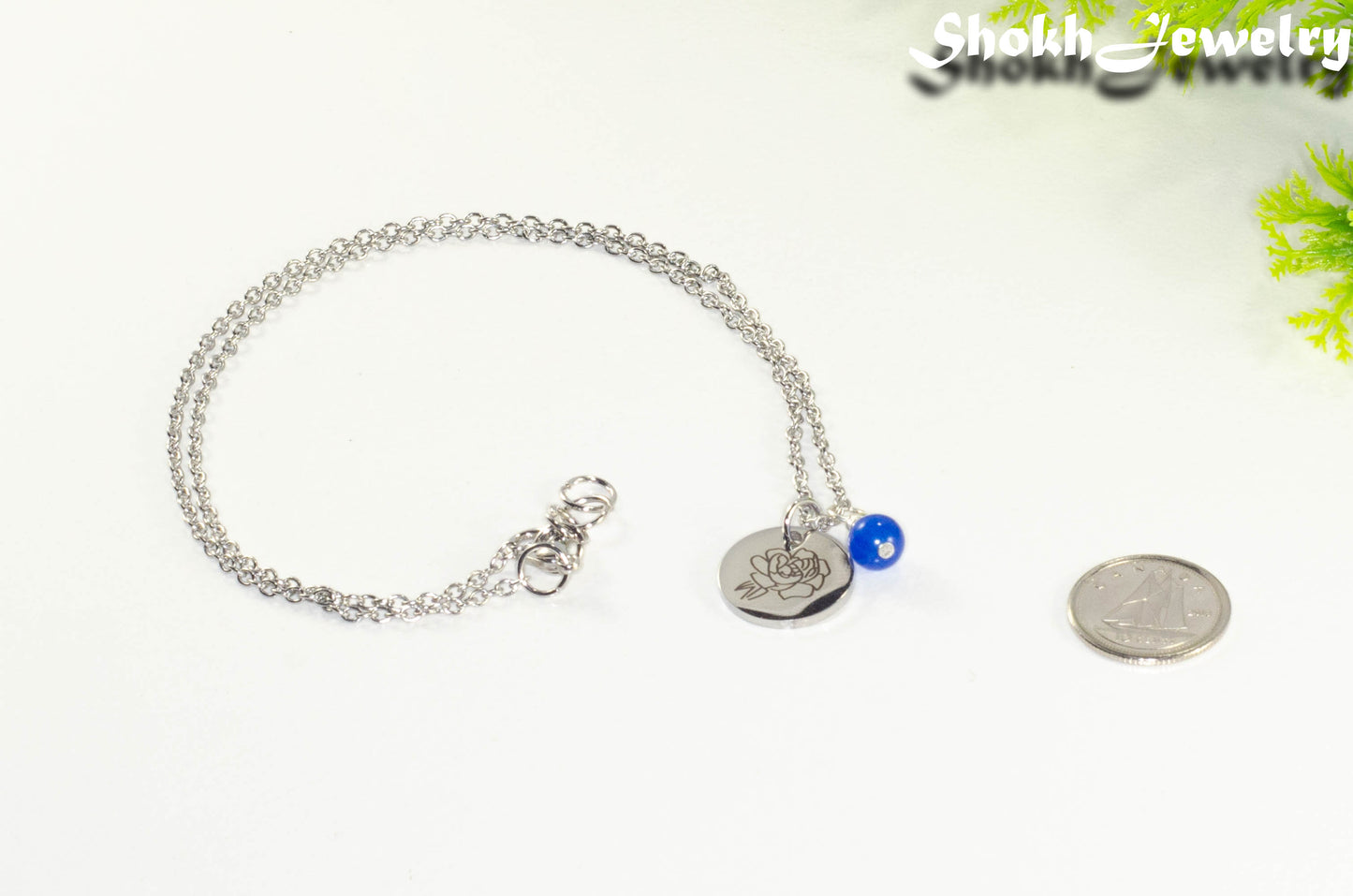 September Birth Flower Necklace with Sapphire Birthstone Pendant beside a dime.
