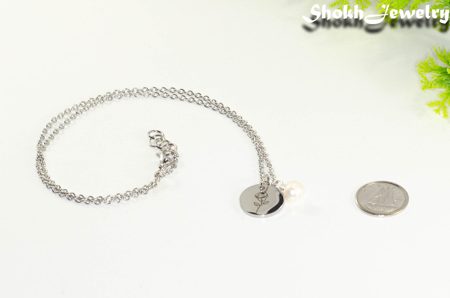June Birth Flower Necklace with Freshwater Pearl Birthstone Pendant beside a dime.