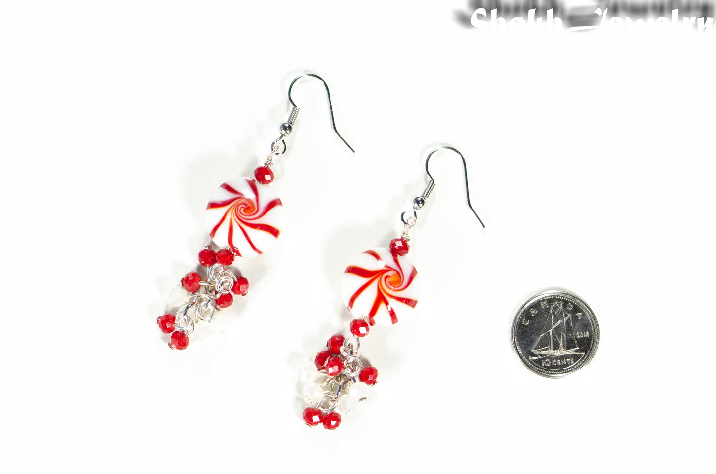 Statement Christmas Peppermint Glass Bead Earrings beside a dime.