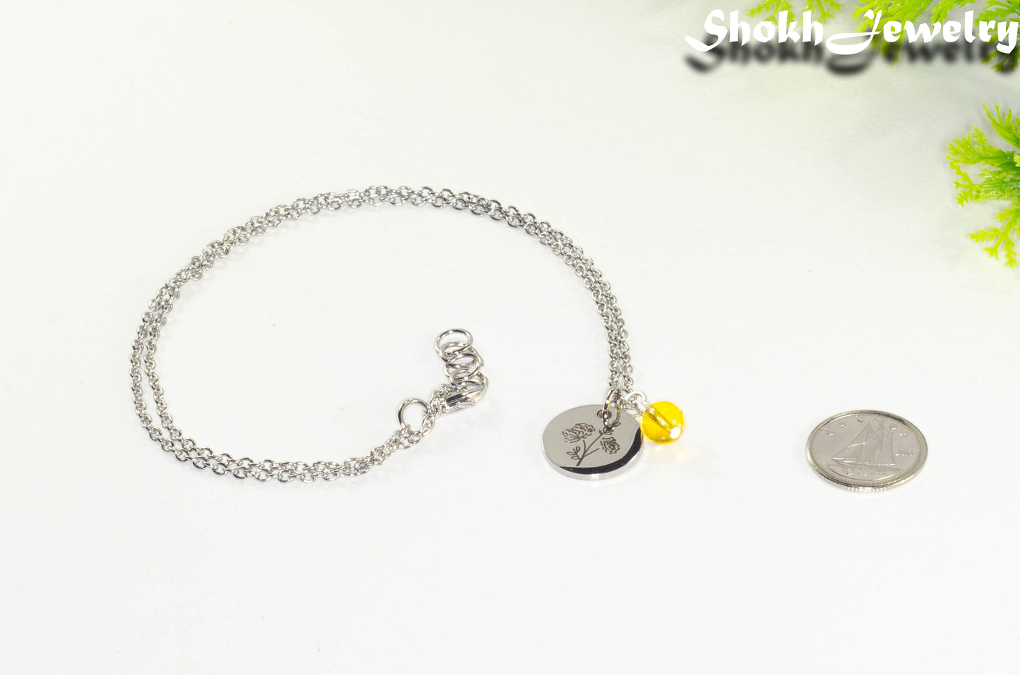 November Birth Flower Necklace with Citrine Birthstone Pendant beside a dime.