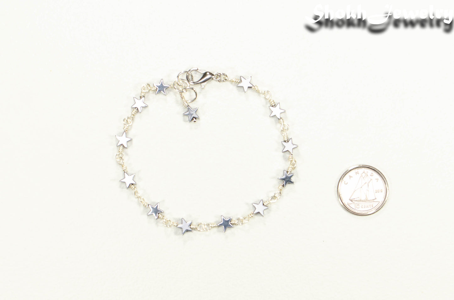 Small Hematite Star Link Anklet beside a dime.