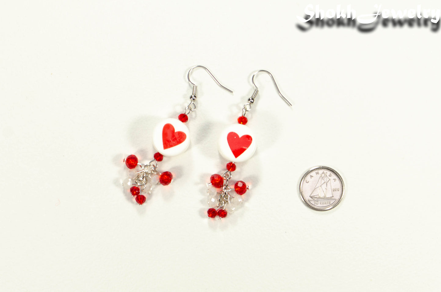 Statement Red Heart Ceramic Bead Earrings beside a dime.