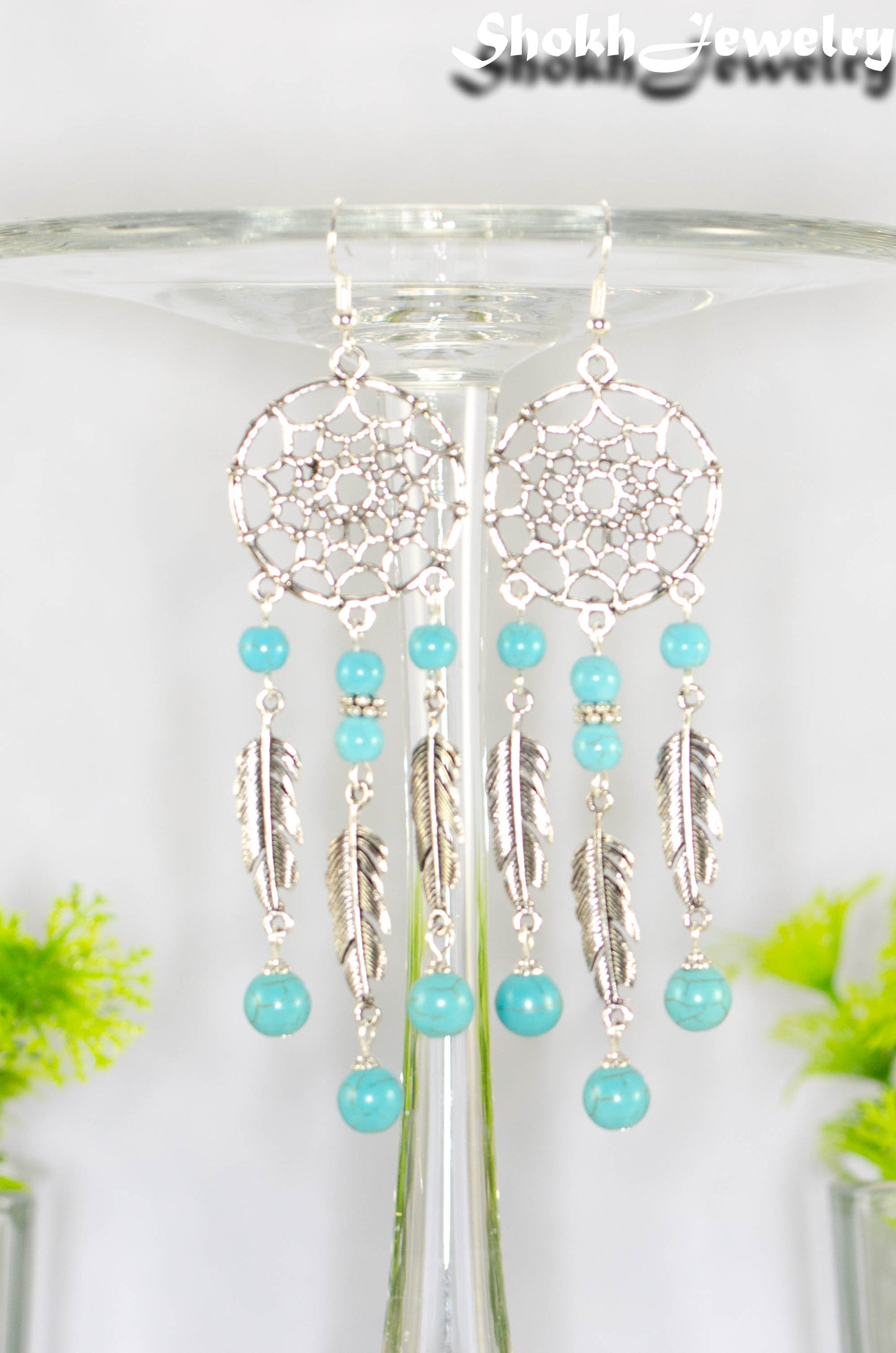 Close up of Extra Long Turquoise Howlite Dream Catcher Earrings.