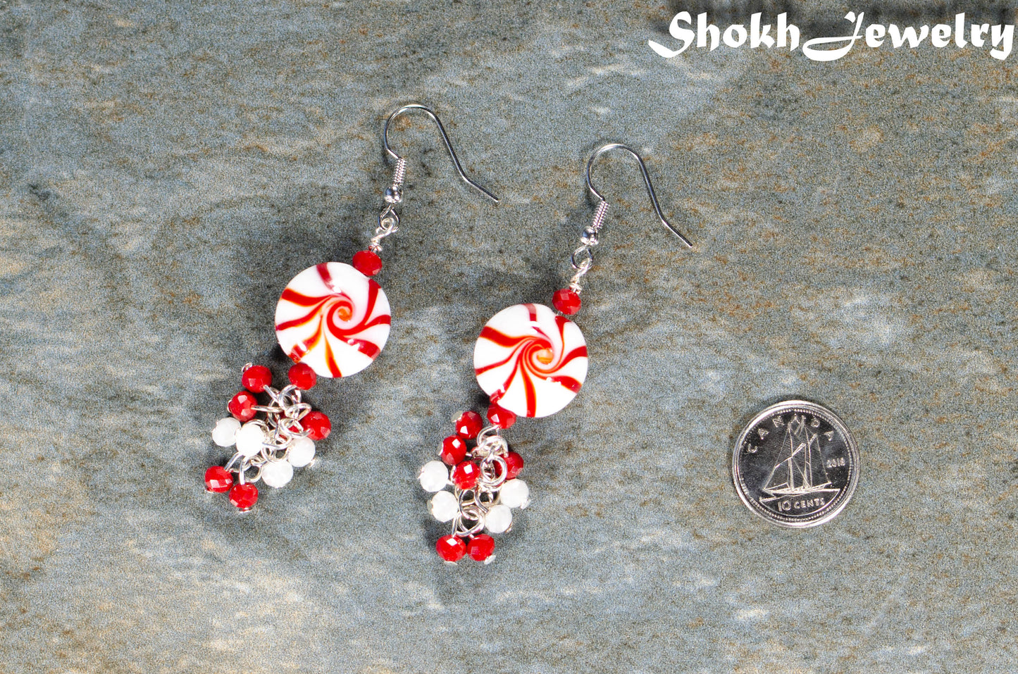 Statement Christmas Peppermint Glass Bead Earrings beside a dime.