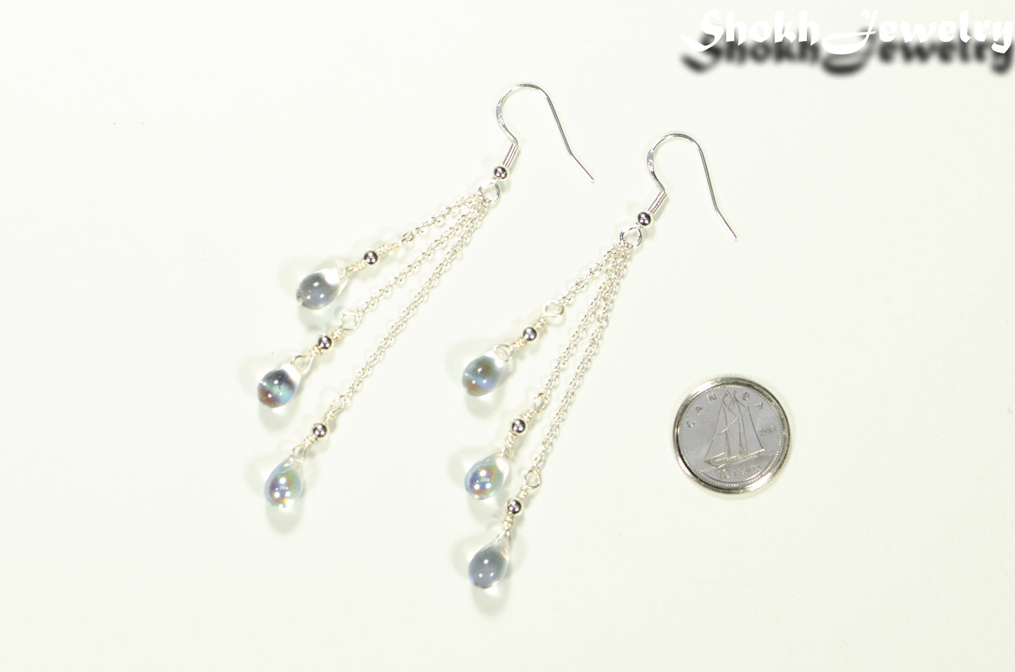 Long Silver Plated Chain and Czech Teardrop Crystal Earrings beside a dime.
