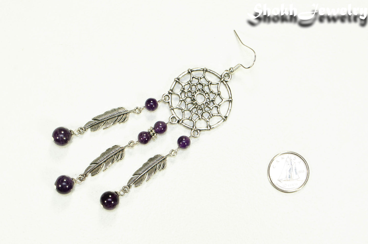 Extra Long Amethyst Dream Catcher Earring beside a dime.