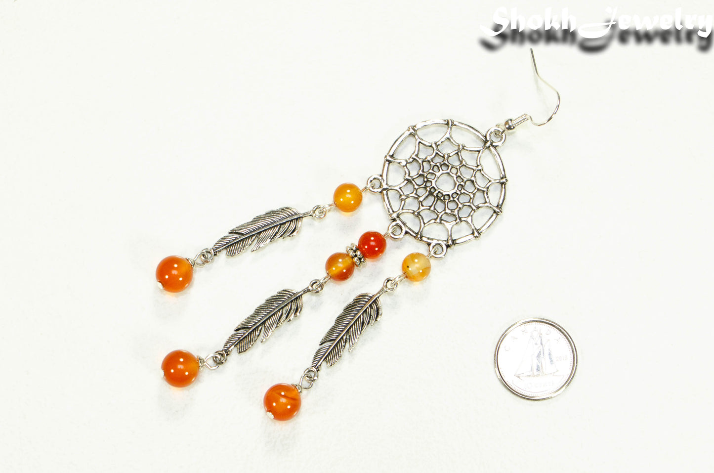 Extra Long Carnelian Dream Catcher Earring beside a dime.