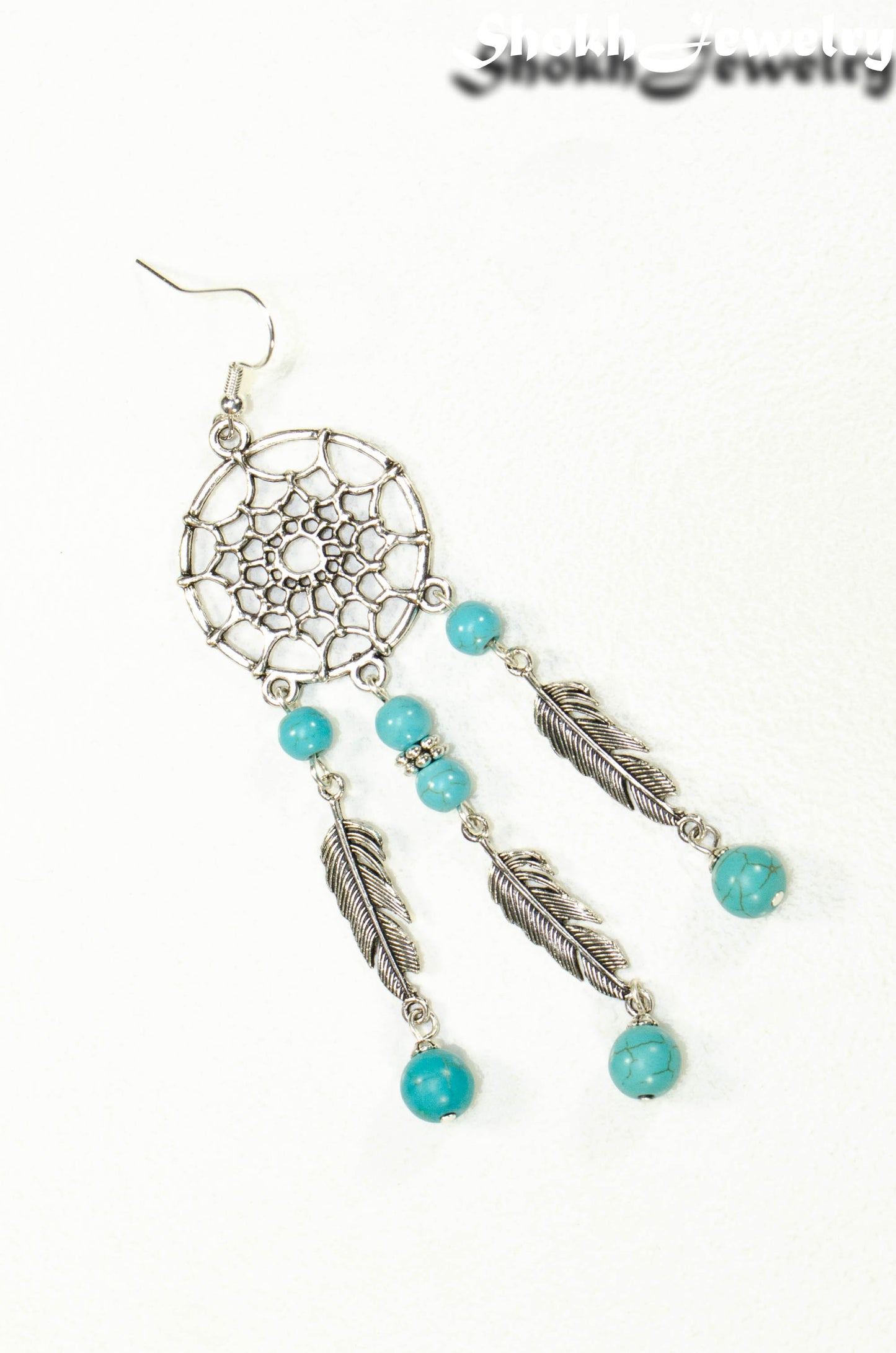 Top view of Extra Long Turquoise Howlite Dream Catcher Earrings.