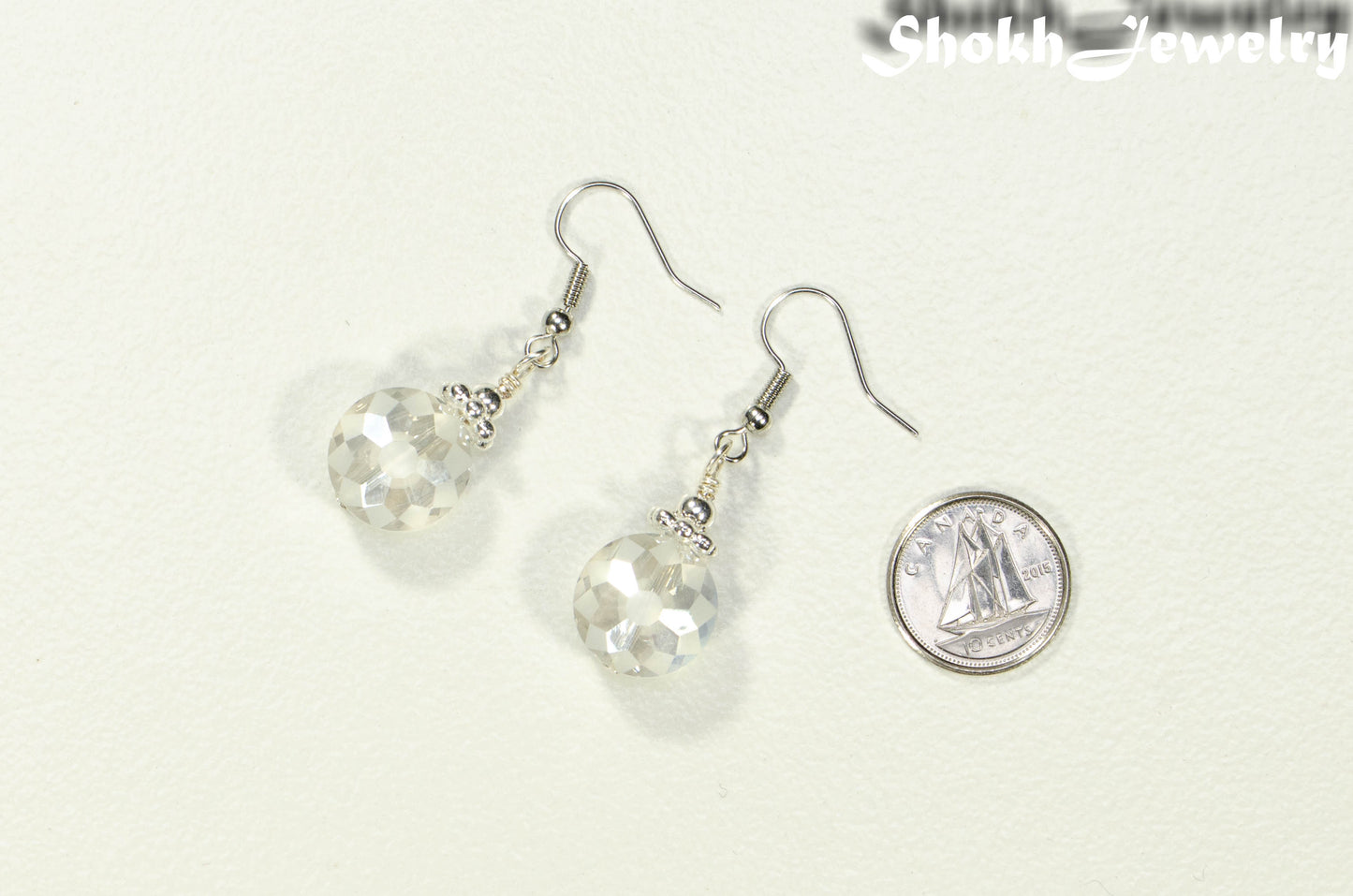 Frosted Glass Crystal Beads Earrings beside a dime.